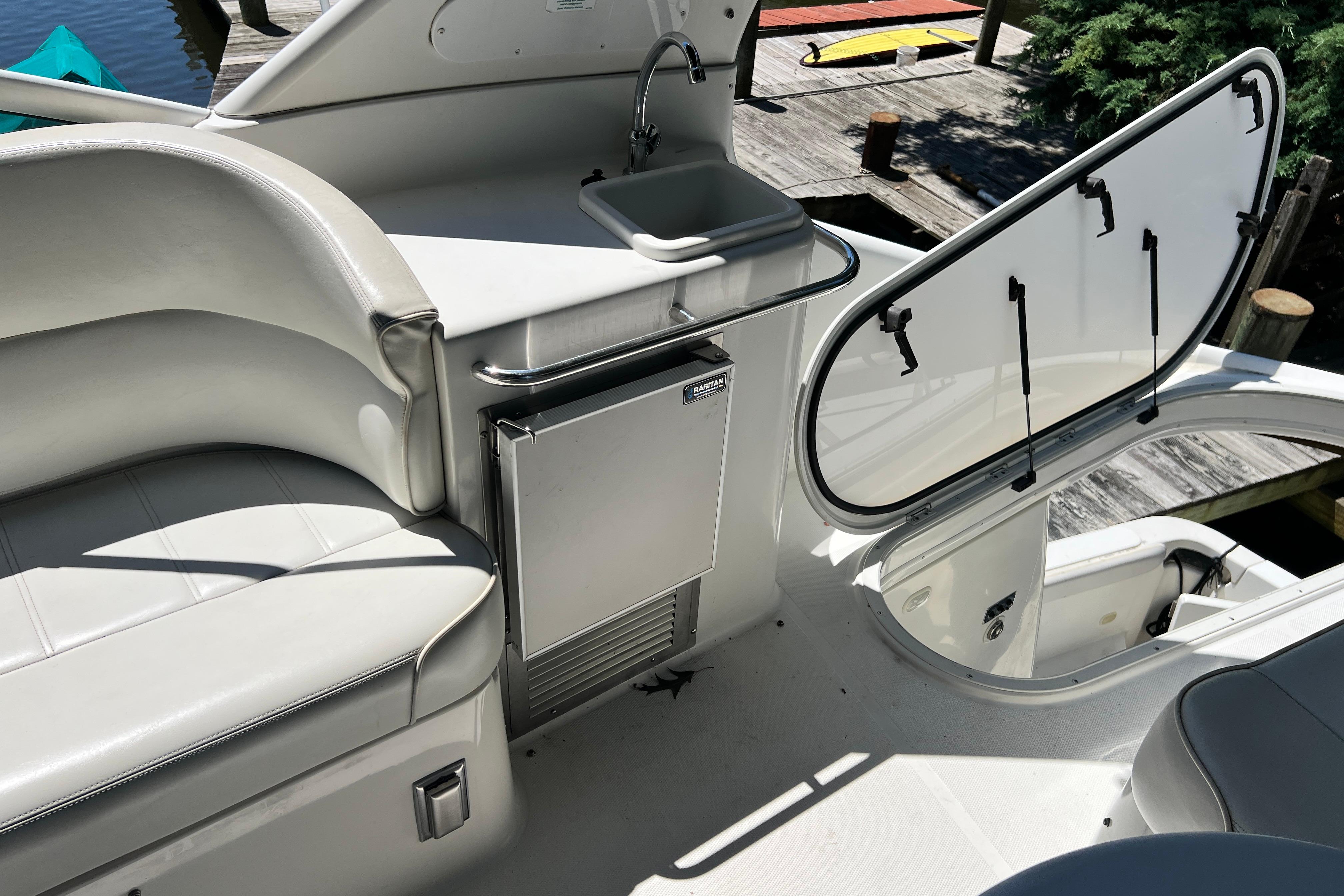 2003 Carver 450 Voyager Pilothouse interior with sink, seating, and open hatch.
