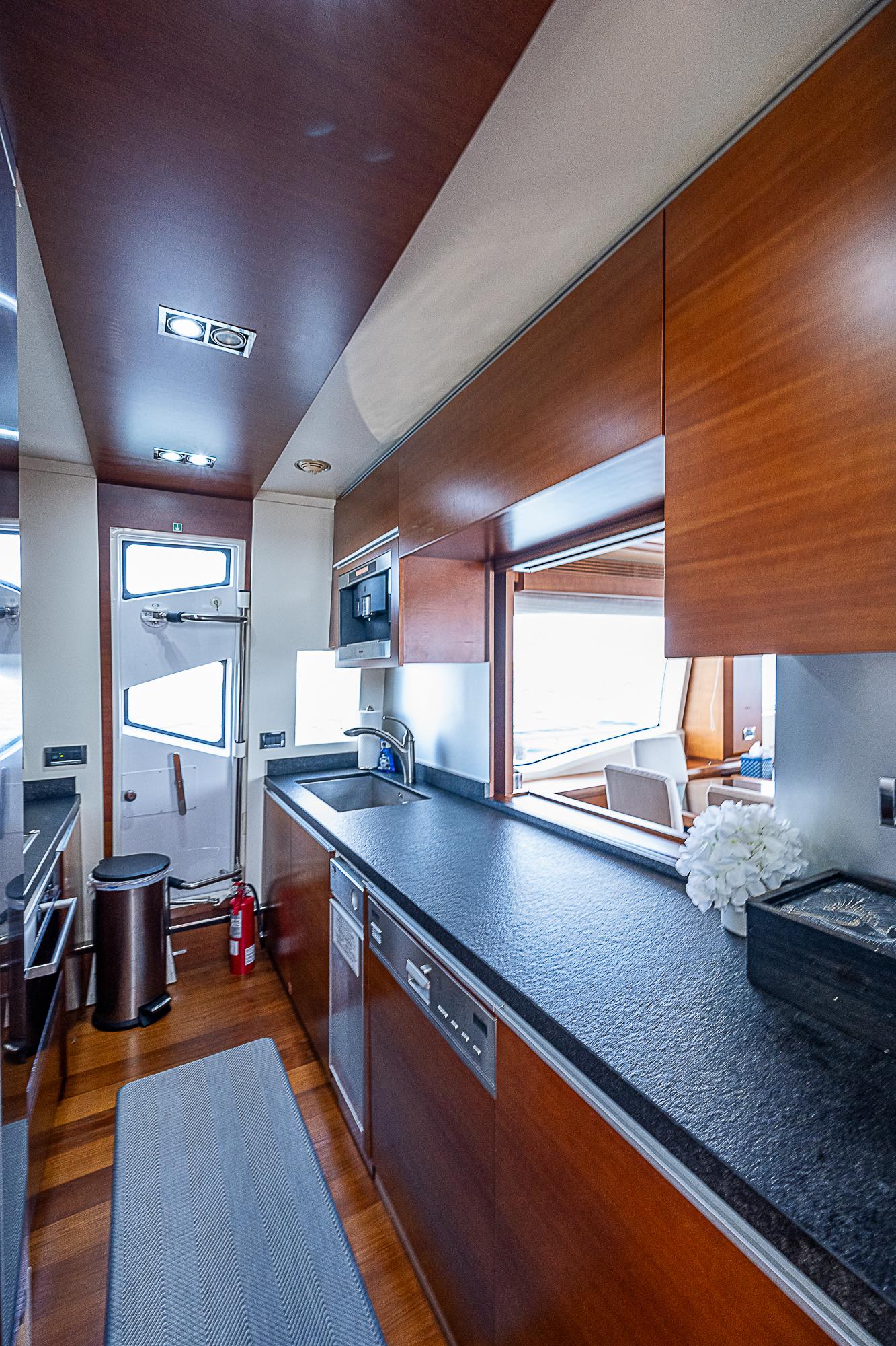 Luxurious kitchen interior of 2011 Azimut 82 yacht with modern amenities.