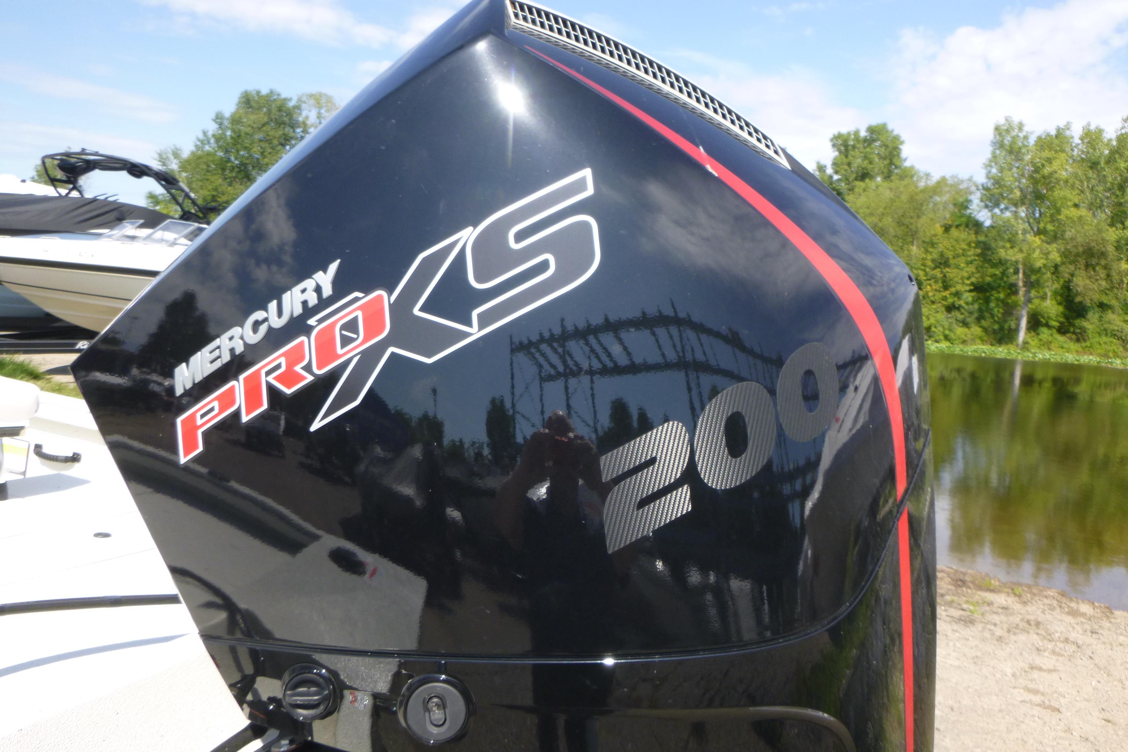 Mercury Pro XS 200 outboard motor on 2025 Ranger RB210 boat by a lake.