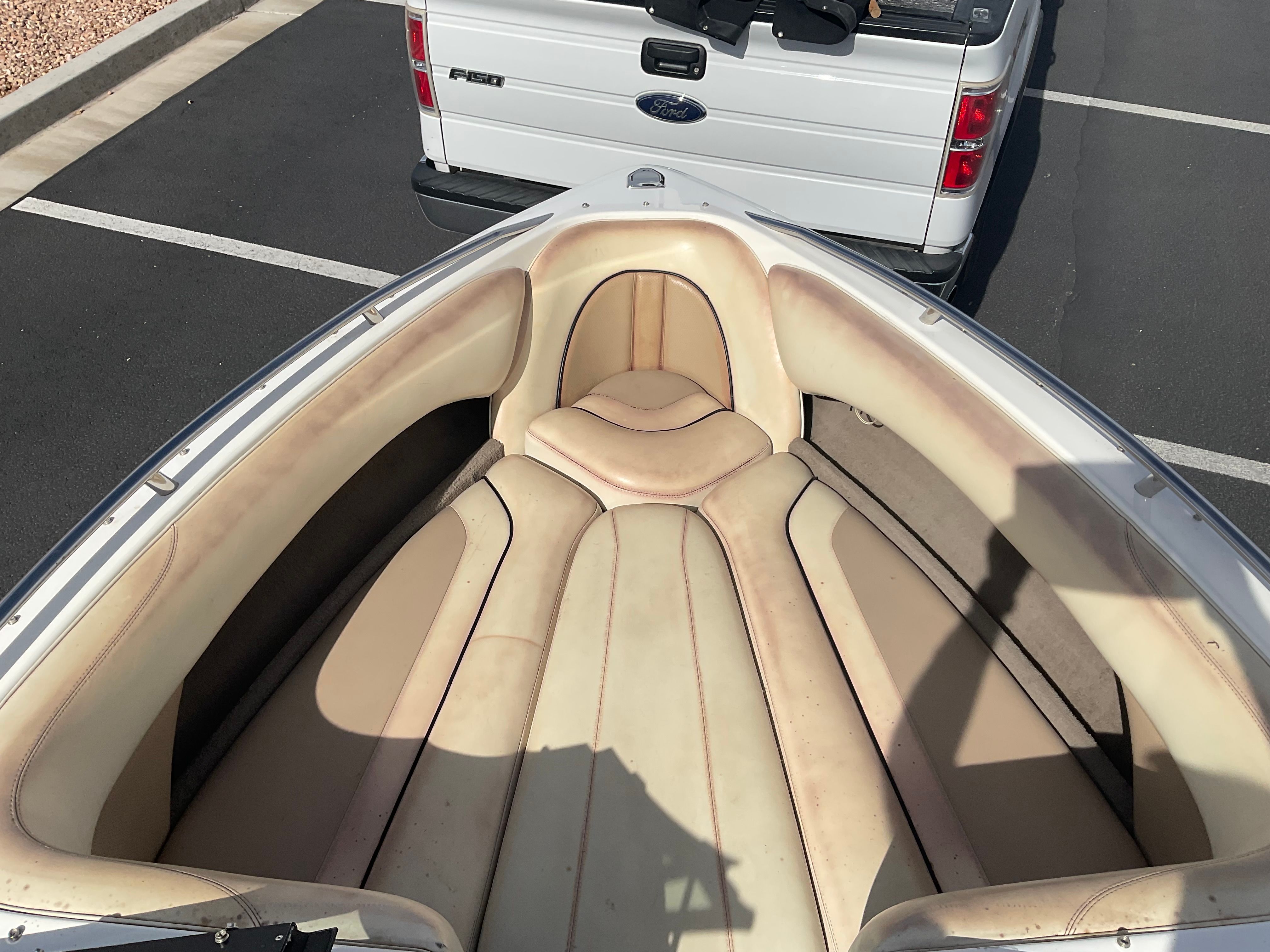 The image shows the bow of a Malibu Wakesetter 23 LSV with beige upholstery.