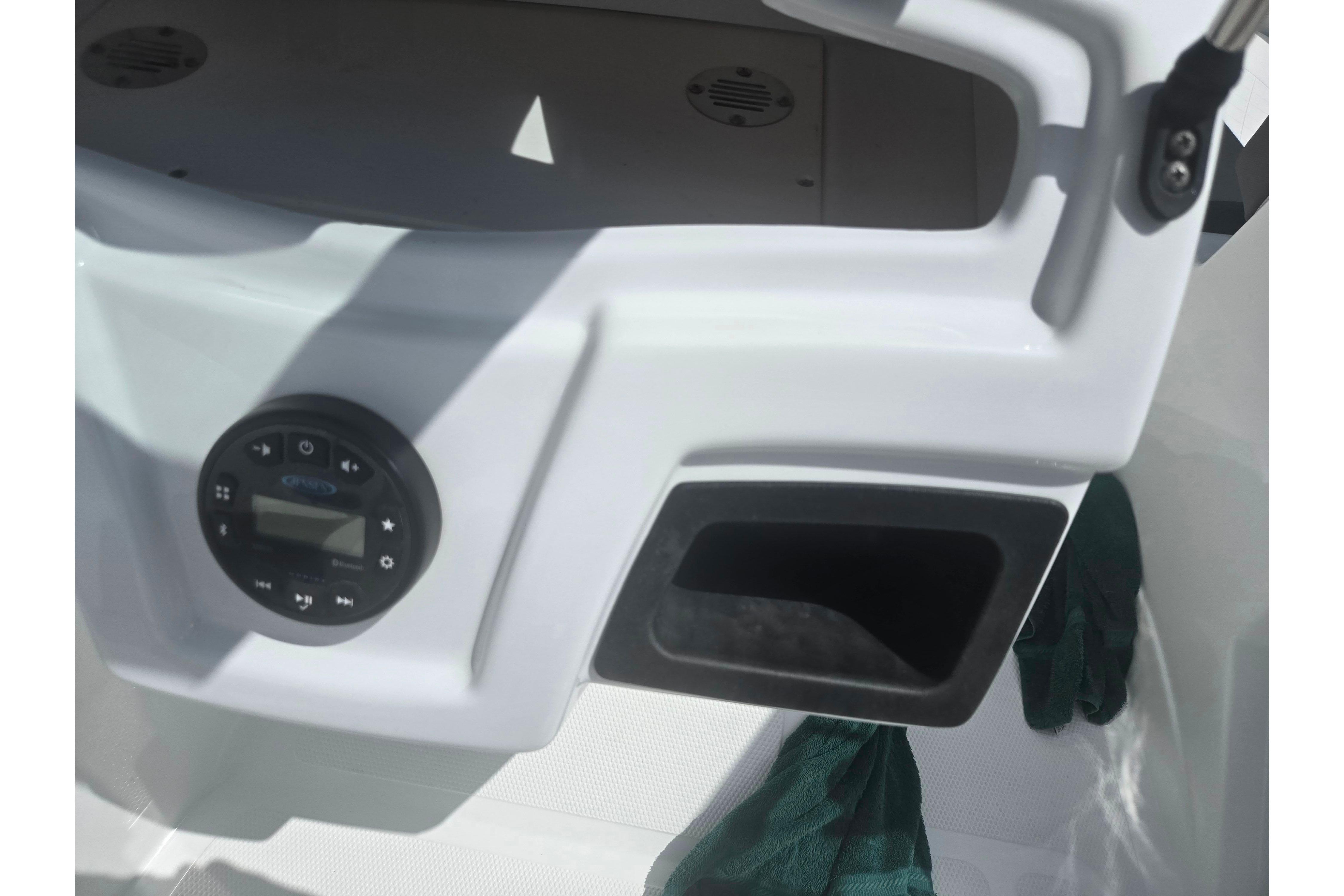 Control panel of 2023 Tahoe 200 S boat with audio system and storage compartment.