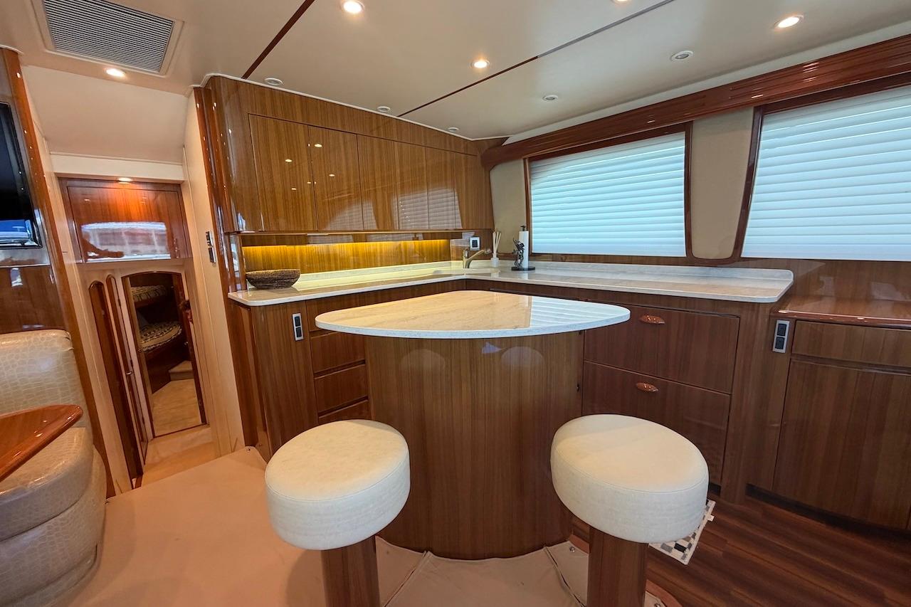 Luxurious interior of a 2012 Viking 50 Convertible yacht with elegant wood finishes and modern amenities.