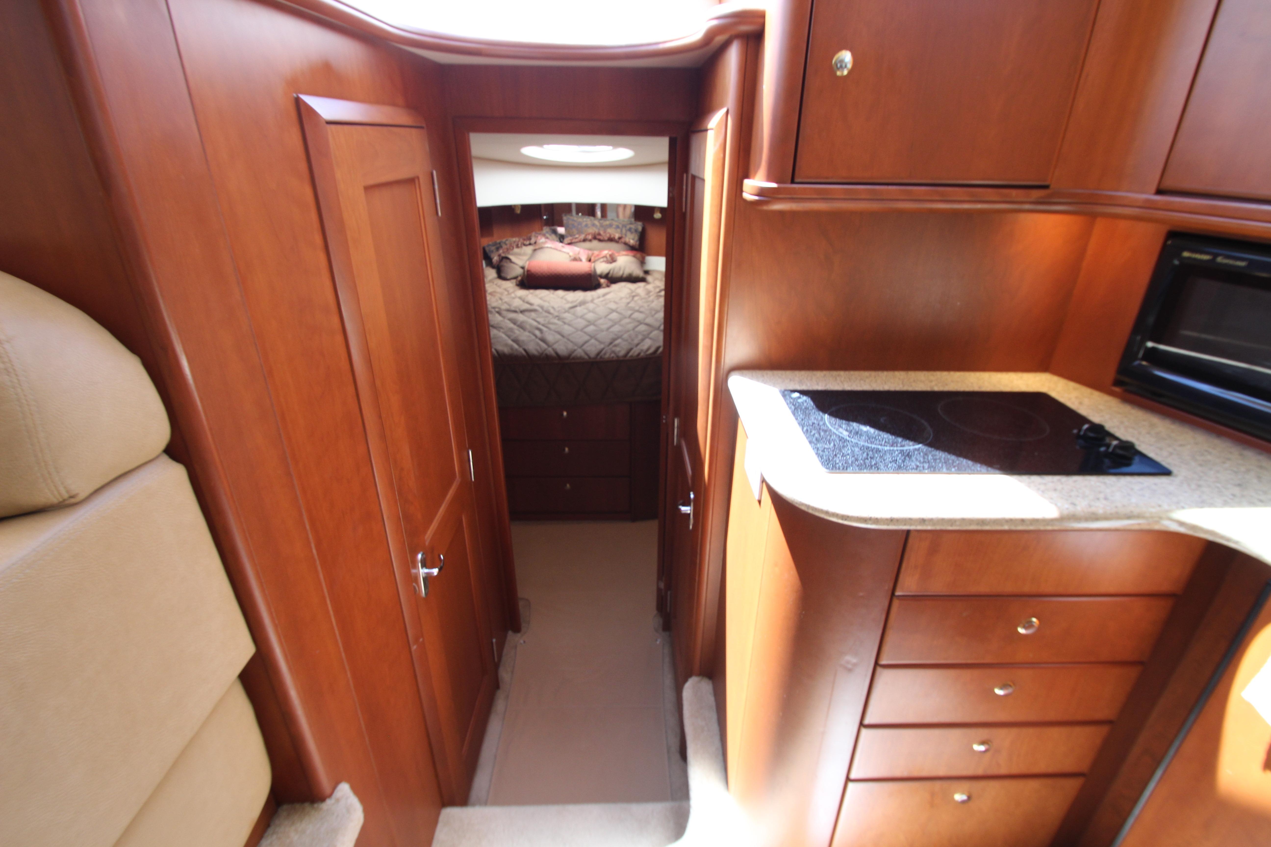 Interior of 2006 Silverton 38 Sport Bridge, featuring wood cabinetry and compact kitchen area.