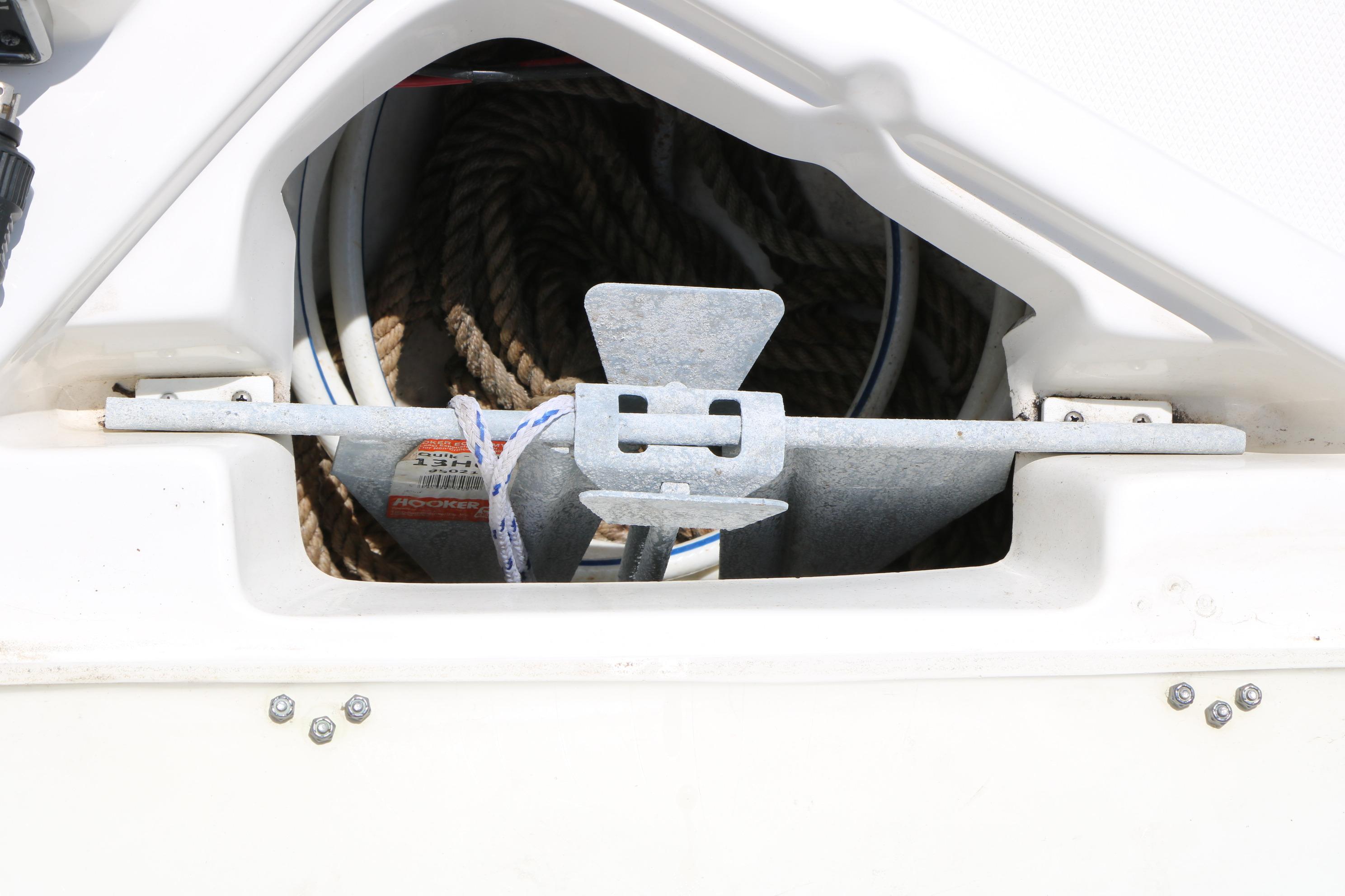 Anchor storage compartment on 2020 NauticStar 2140 Sport boat, featuring secured anchor and rope.