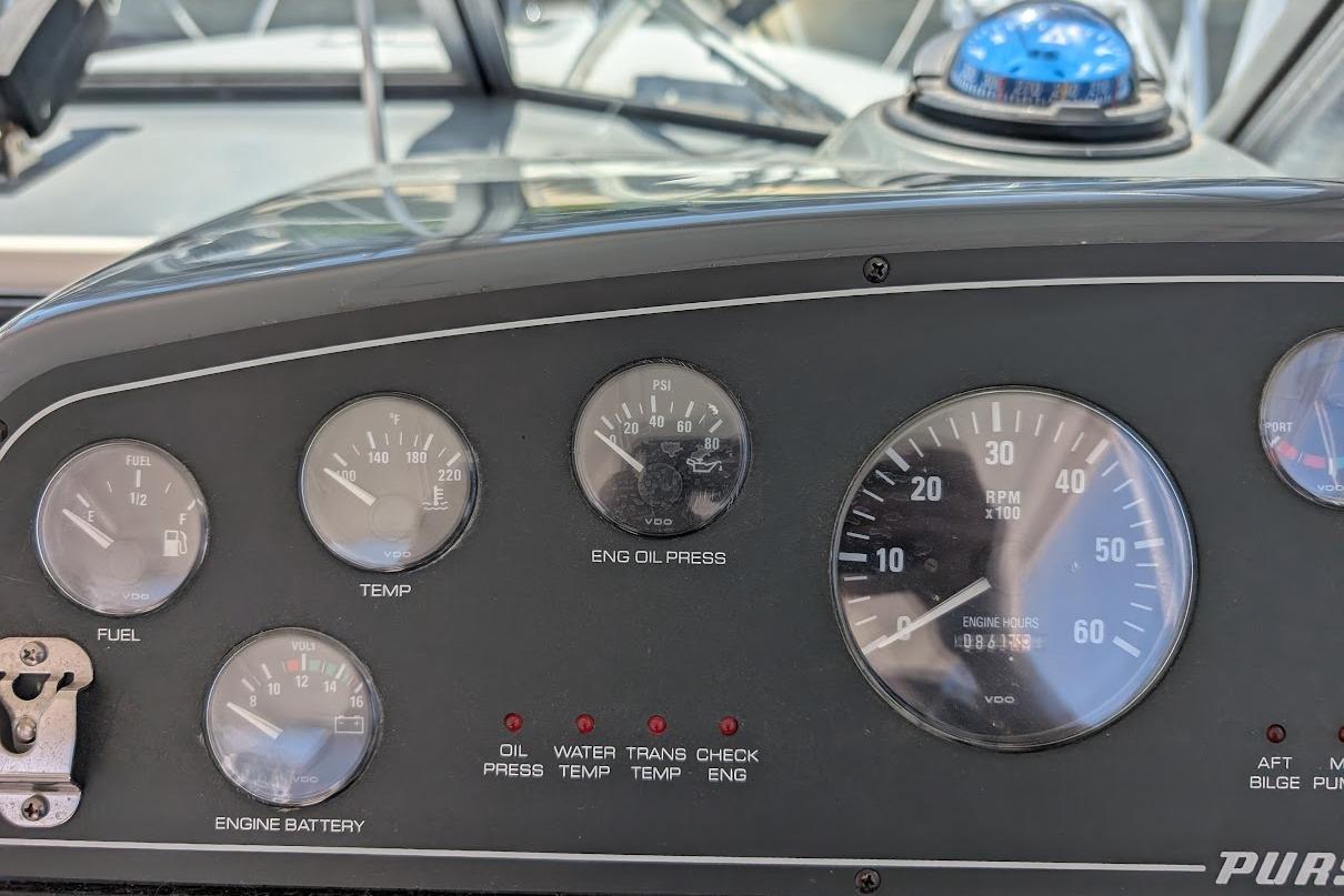 Dashboard of a 2000 Pursuit 3400 Express boat with gauges and indicators.
