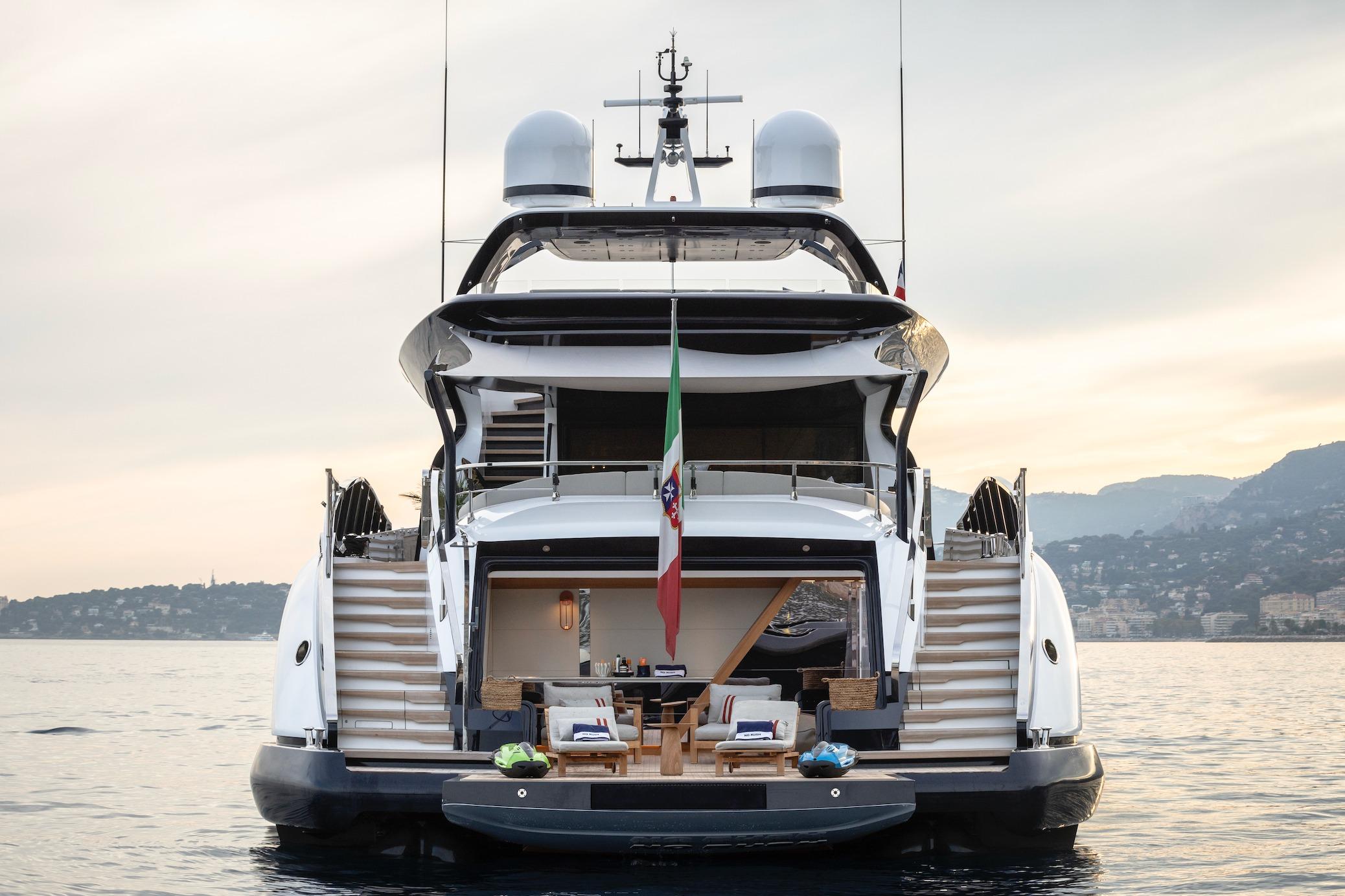 2023 Overmarine Mangusta 165 Rev yacht, rear view, luxurious deck, serene sea backdrop.