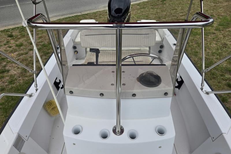1996 Boston Whaler Outrage 17 boat interior with steering console and seating.