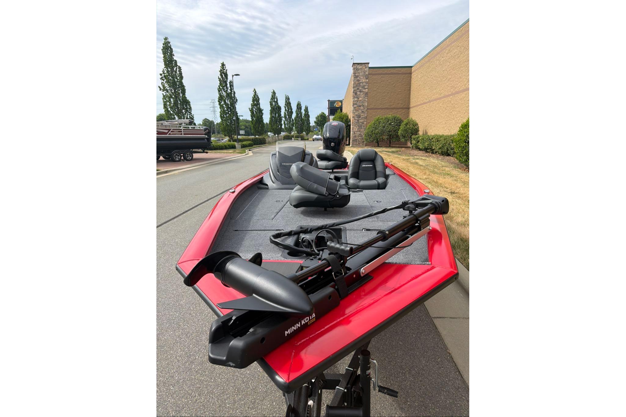 2026 Tracker Pro Team 190 boat with red exterior and fishing equipment.