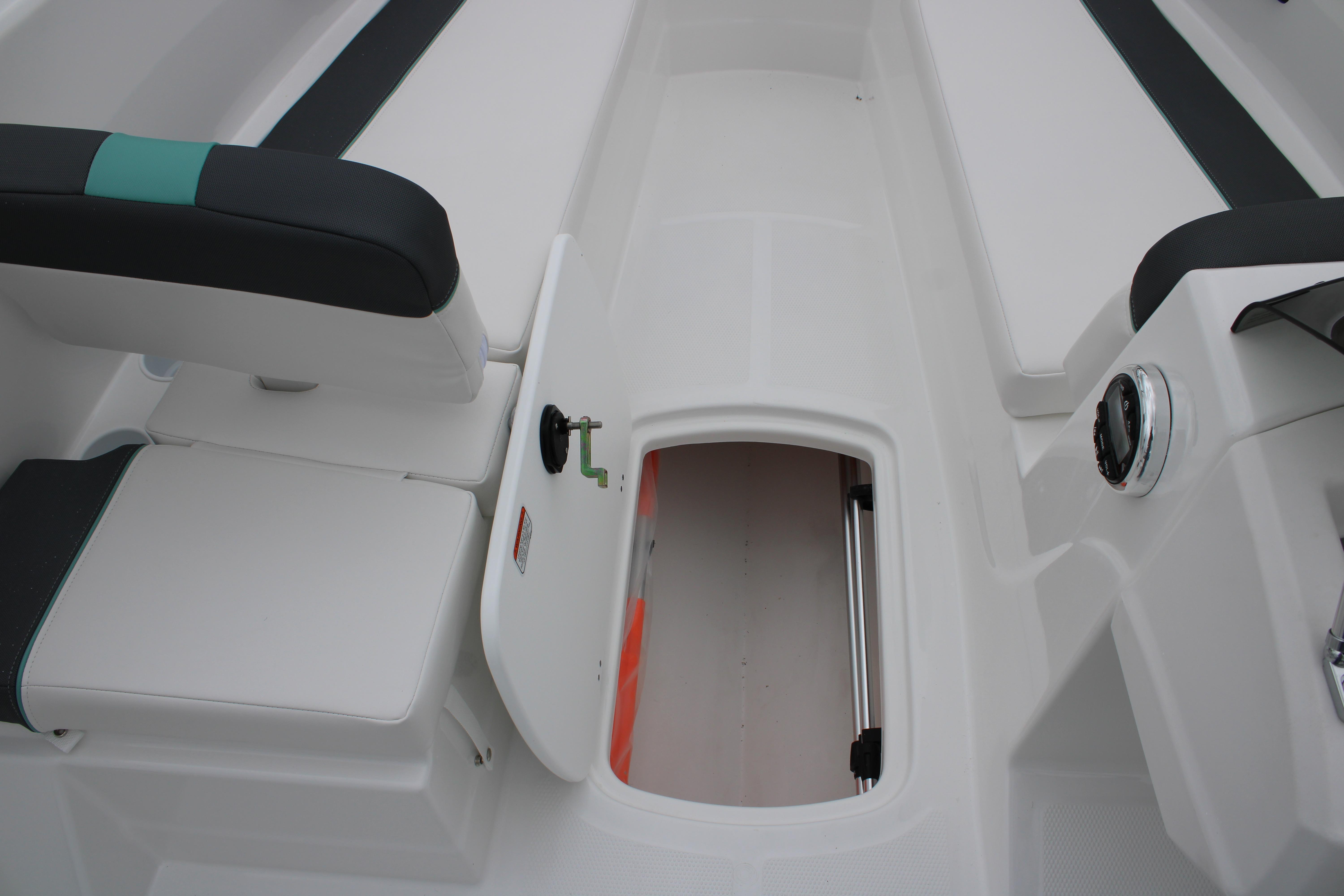 2026 Tahoe T16 boat interior with open storage compartment and cushioned seating.