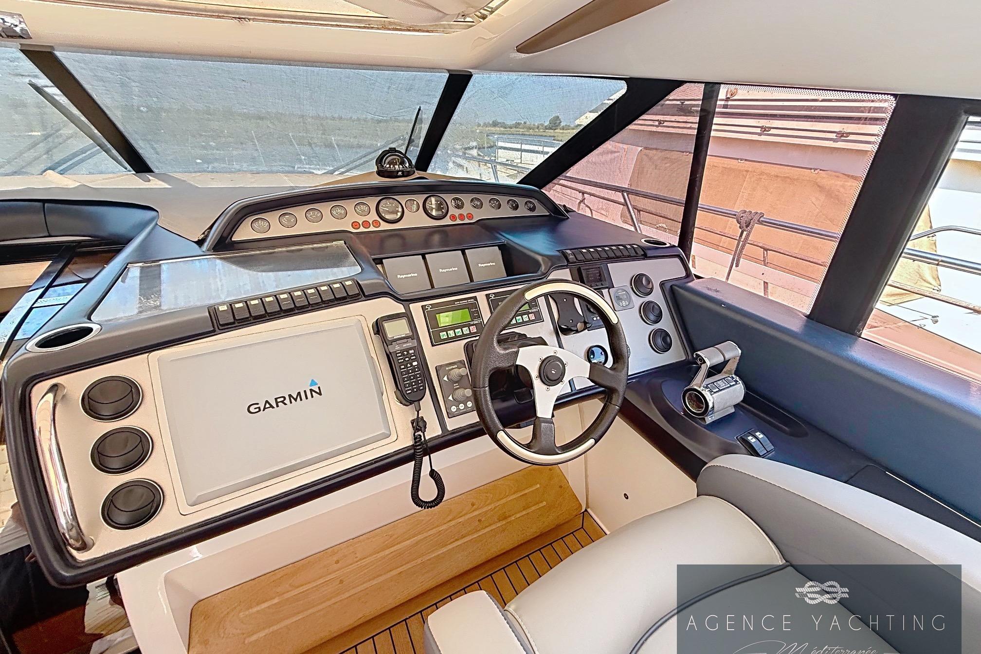 Helm of 2004 Princess V58 yacht with Garmin navigation system and modern controls.