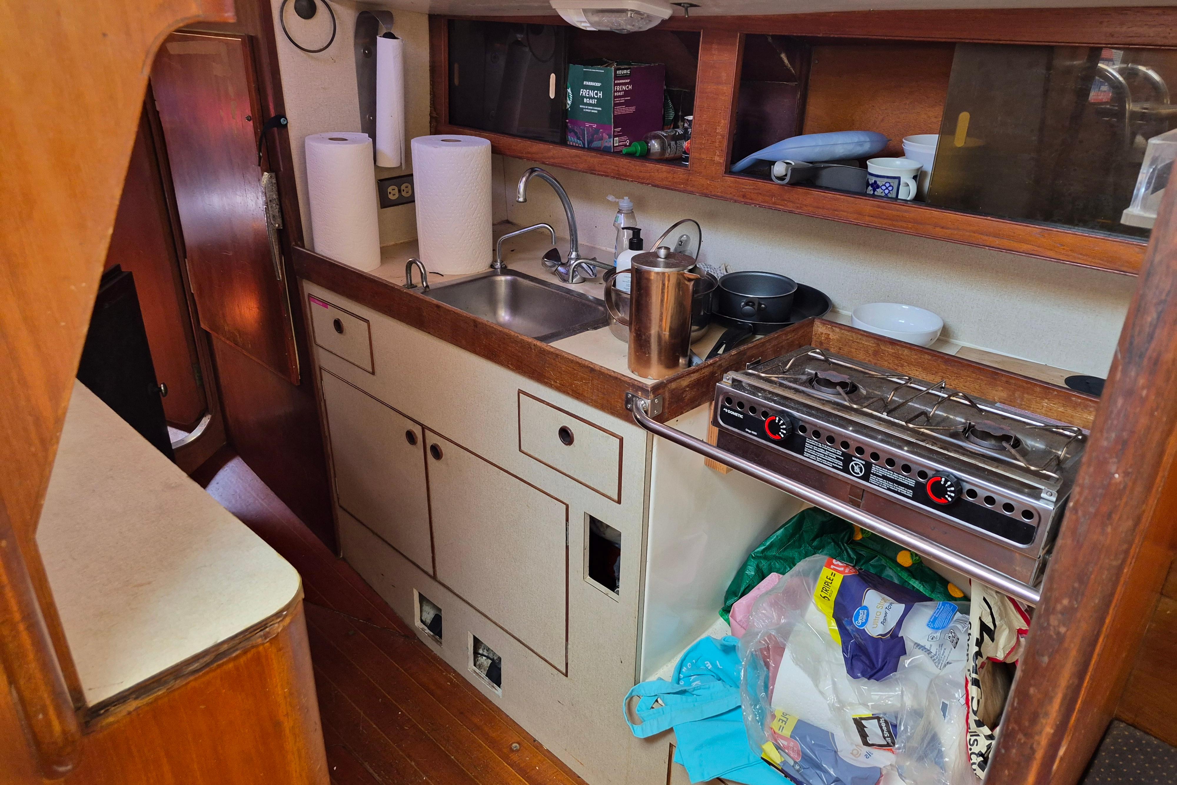 1977 Camper & Nicholsons 42 Ketch galley with stove, sink, and storage.