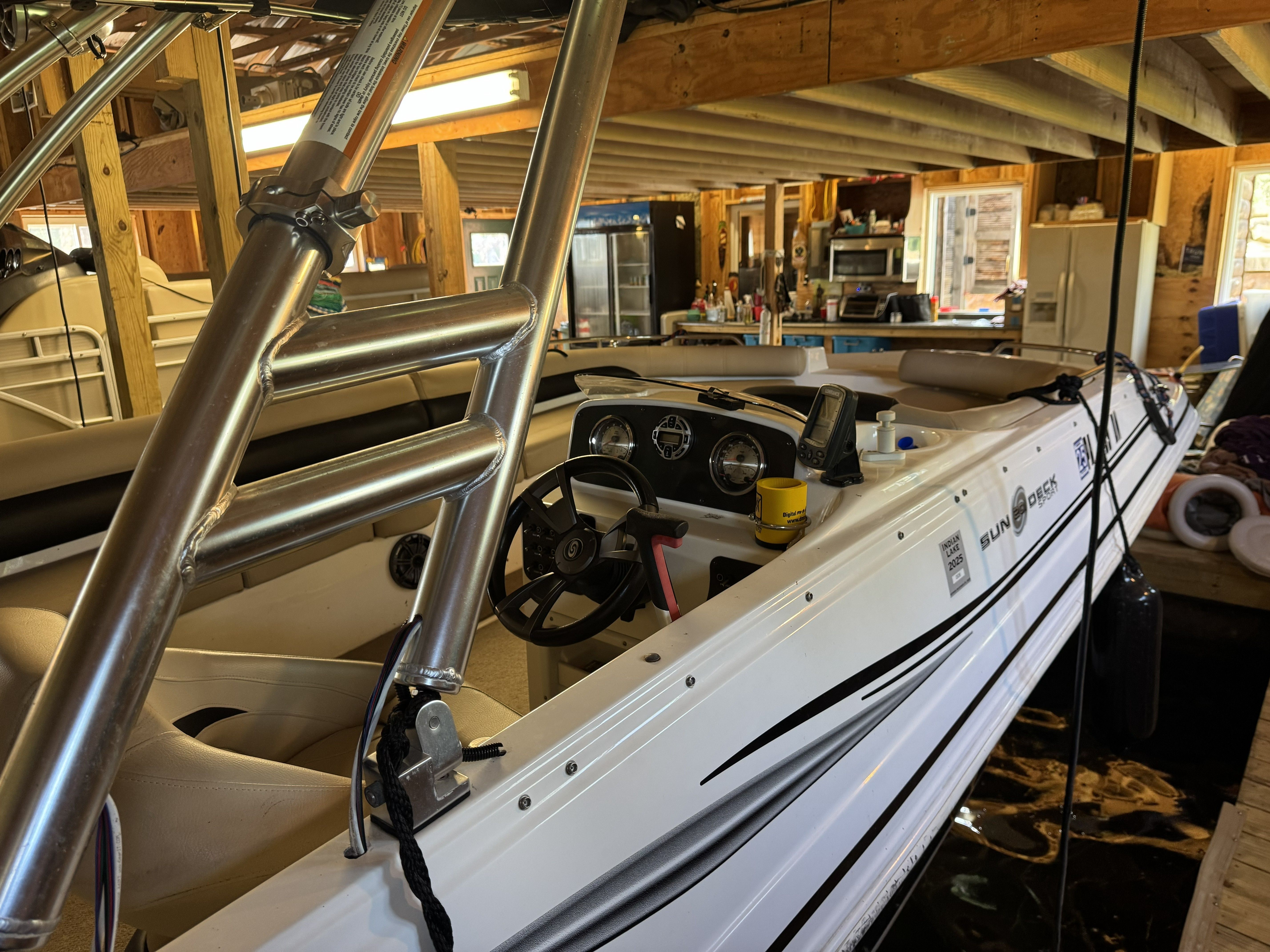 A 2014 Hurricane SS201 I/O boat in a covered dock. The cockpit and helm console are visible.