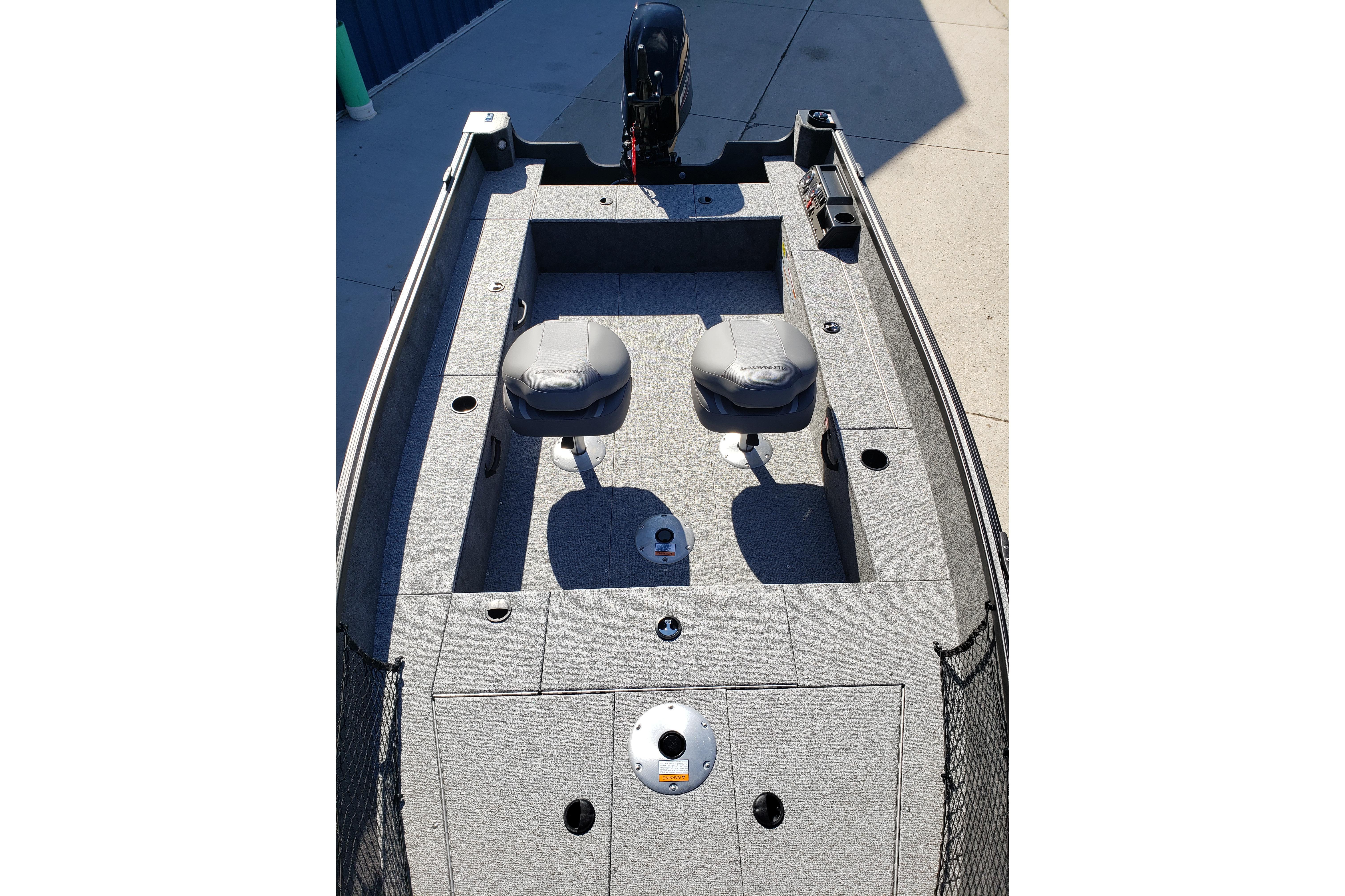 2026 Alumacraft Classic 165 Tiller boat interior with seating and motor.