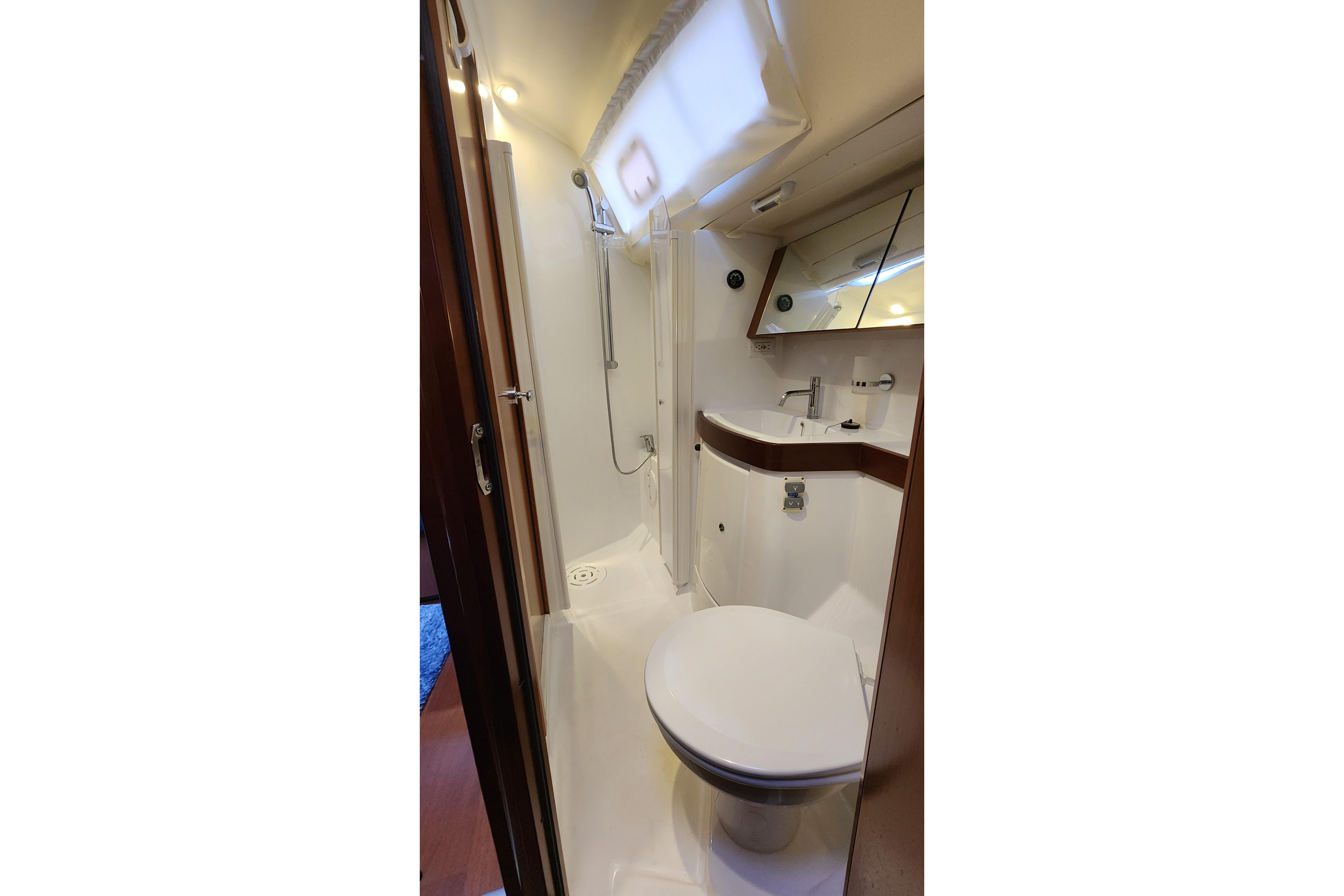 Bathroom interior of 2012 Beneteau Oceanis 40 yacht, featuring shower, sink, and toilet.