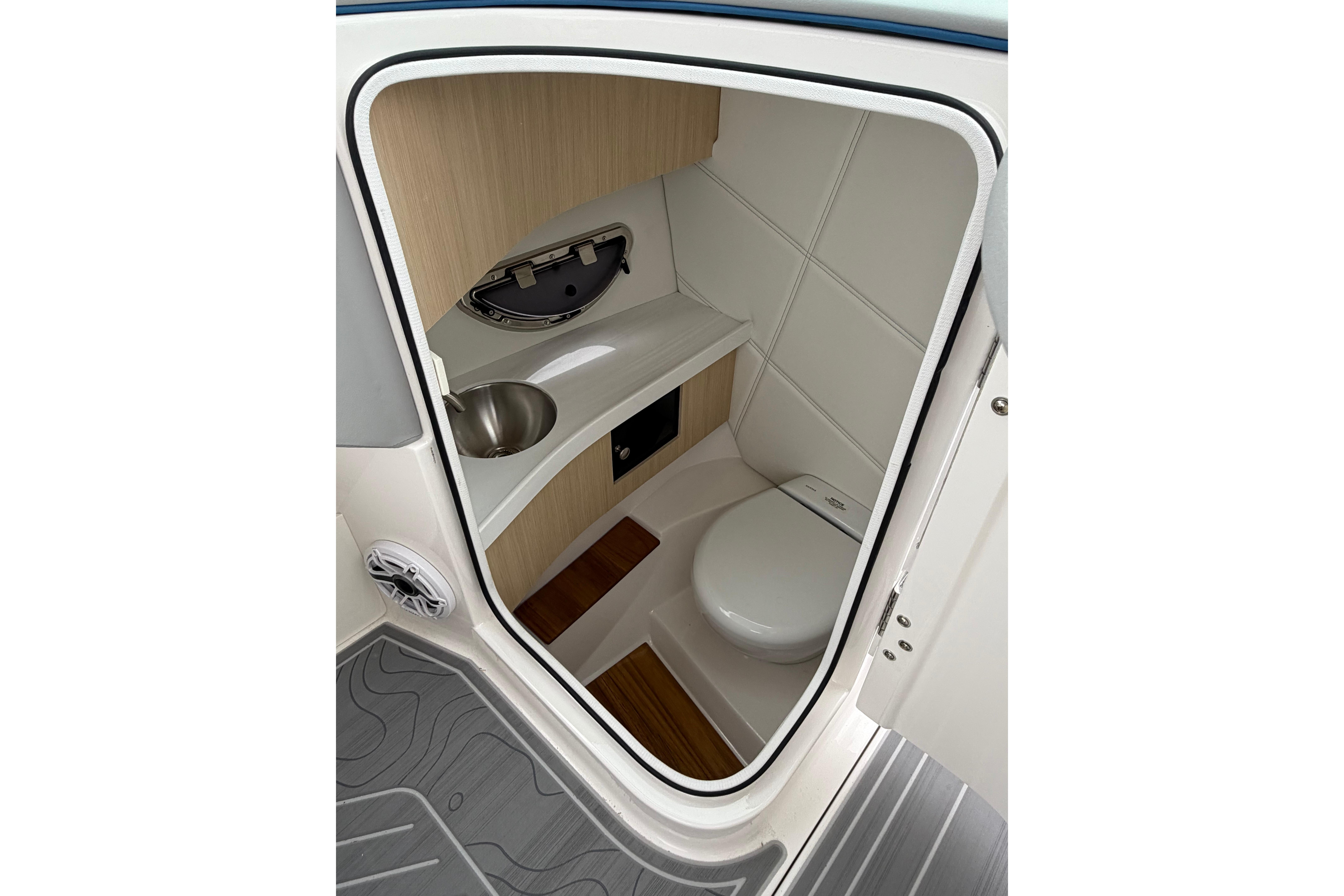 Interior of 2026 Regal LS9 Surf boat bathroom with modern fixtures and wood accents.