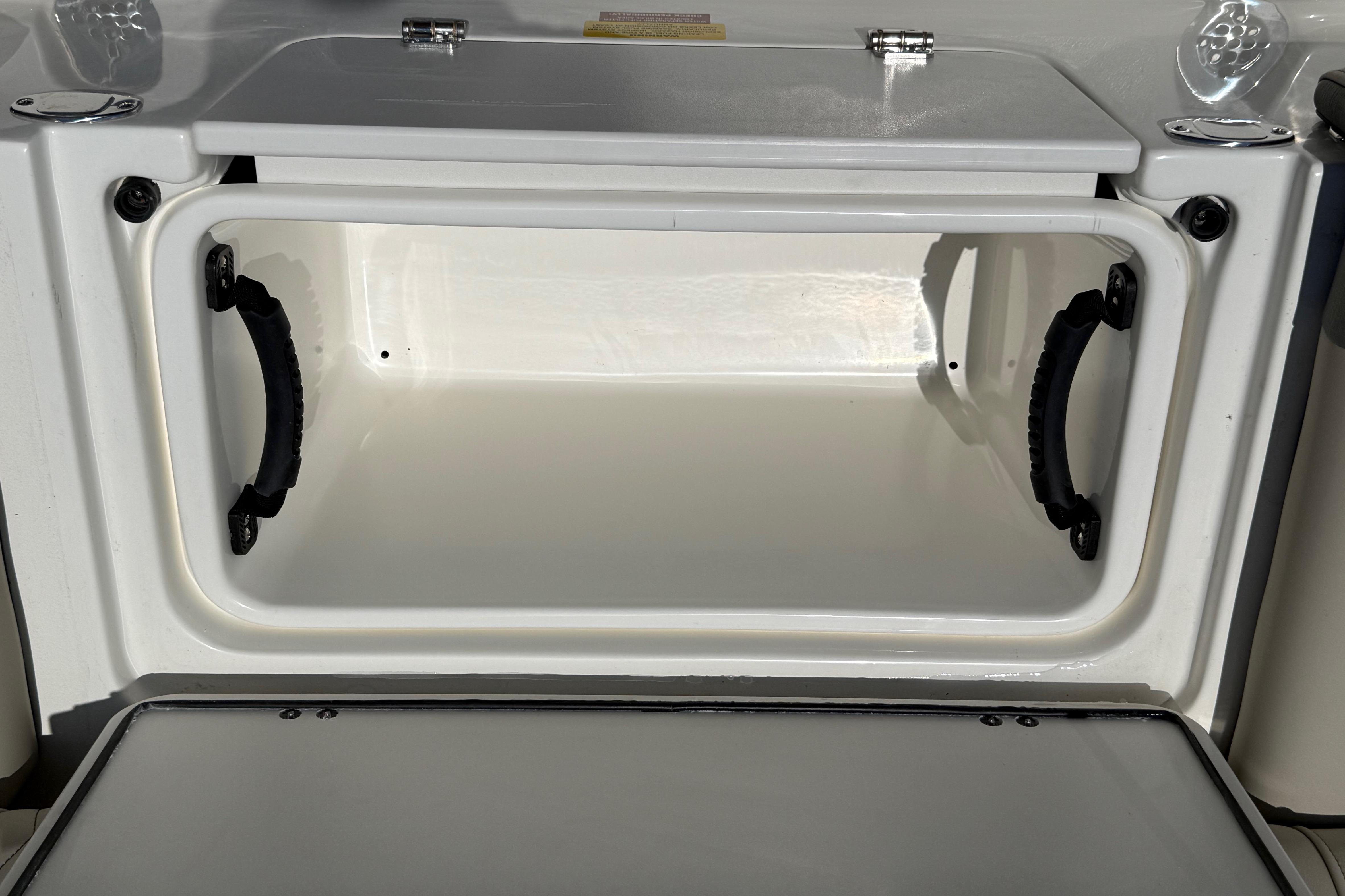 Open storage compartment on 2027 Key West 249 FS boat, featuring sturdy handles.