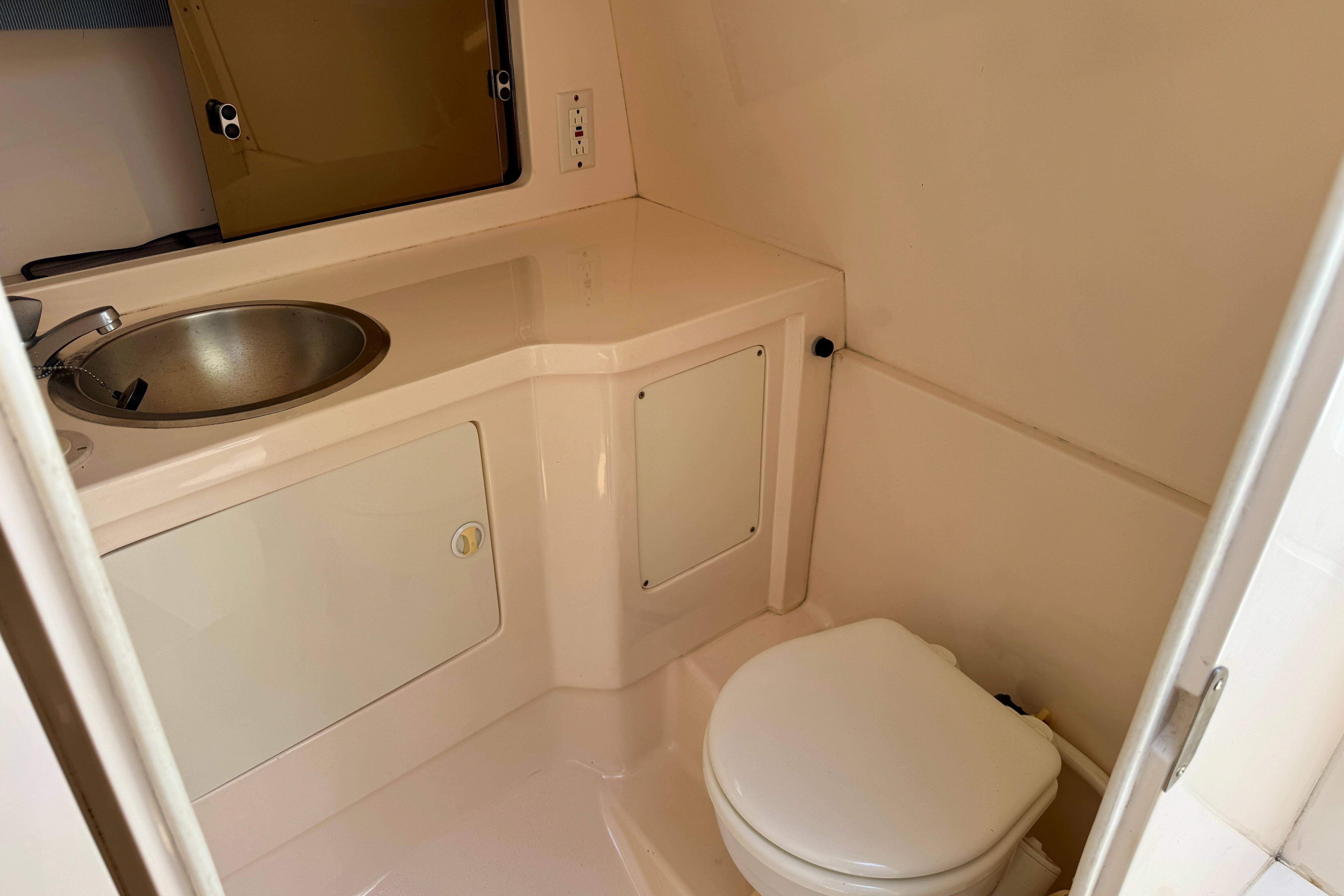 2001 Intrepid 339 Walkaround boat bathroom with sink and toilet.