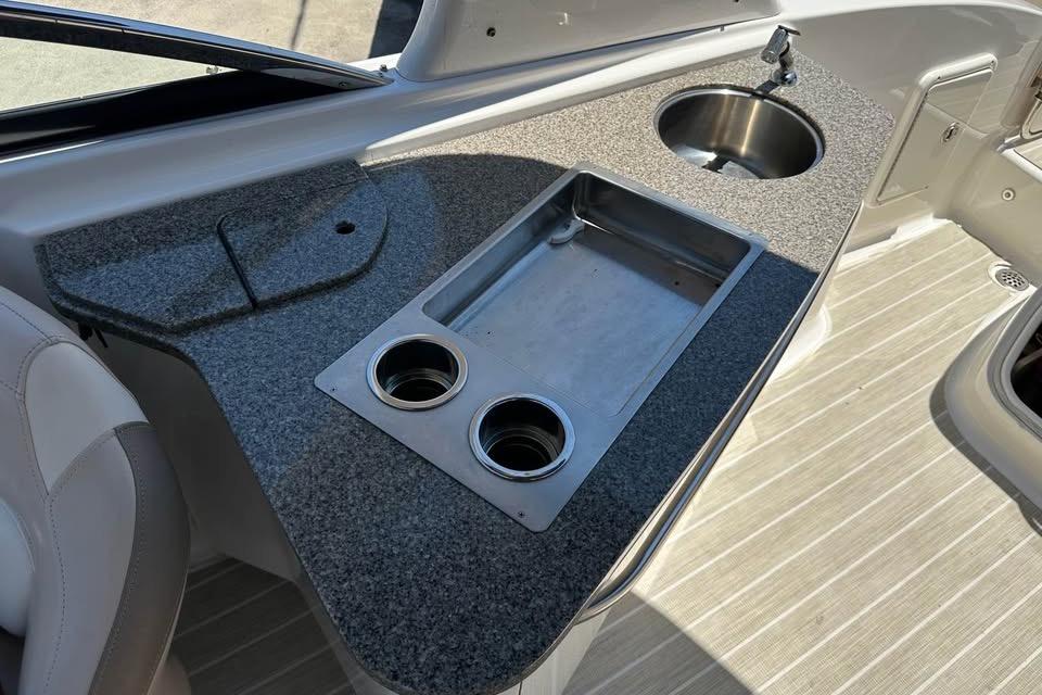 2012 Chaparral 284 Sunesta boat interior with sink and countertop.