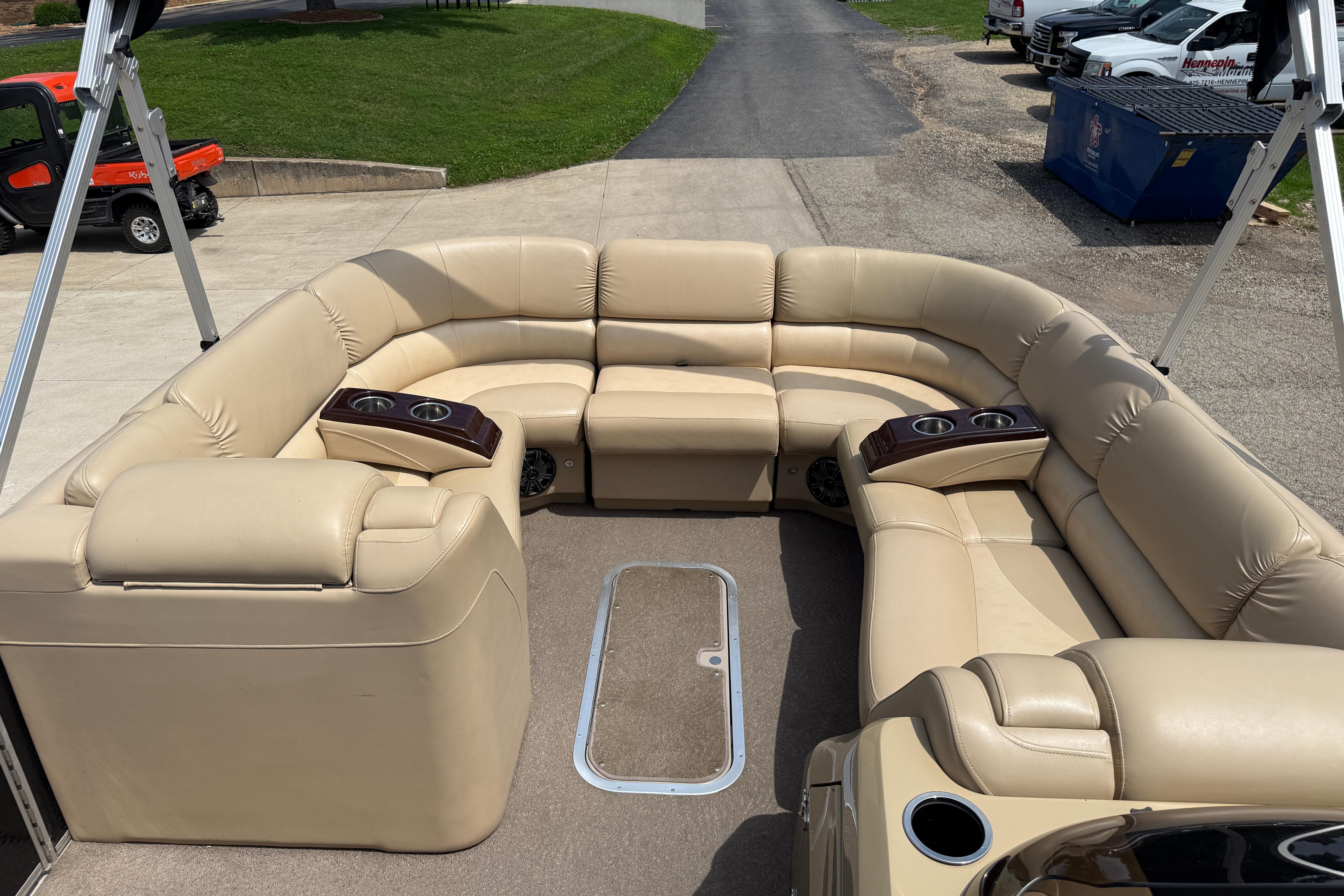 Luxurious beige seating on a 2011 Bennington 2575QCW I/O boat deck.