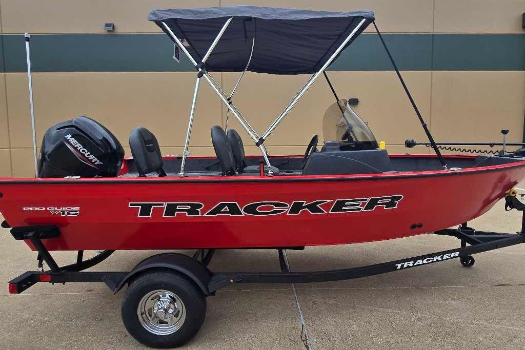 2026 Tracker Pro Guide V-16 SC boat with canopy and Mercury engine on trailer.