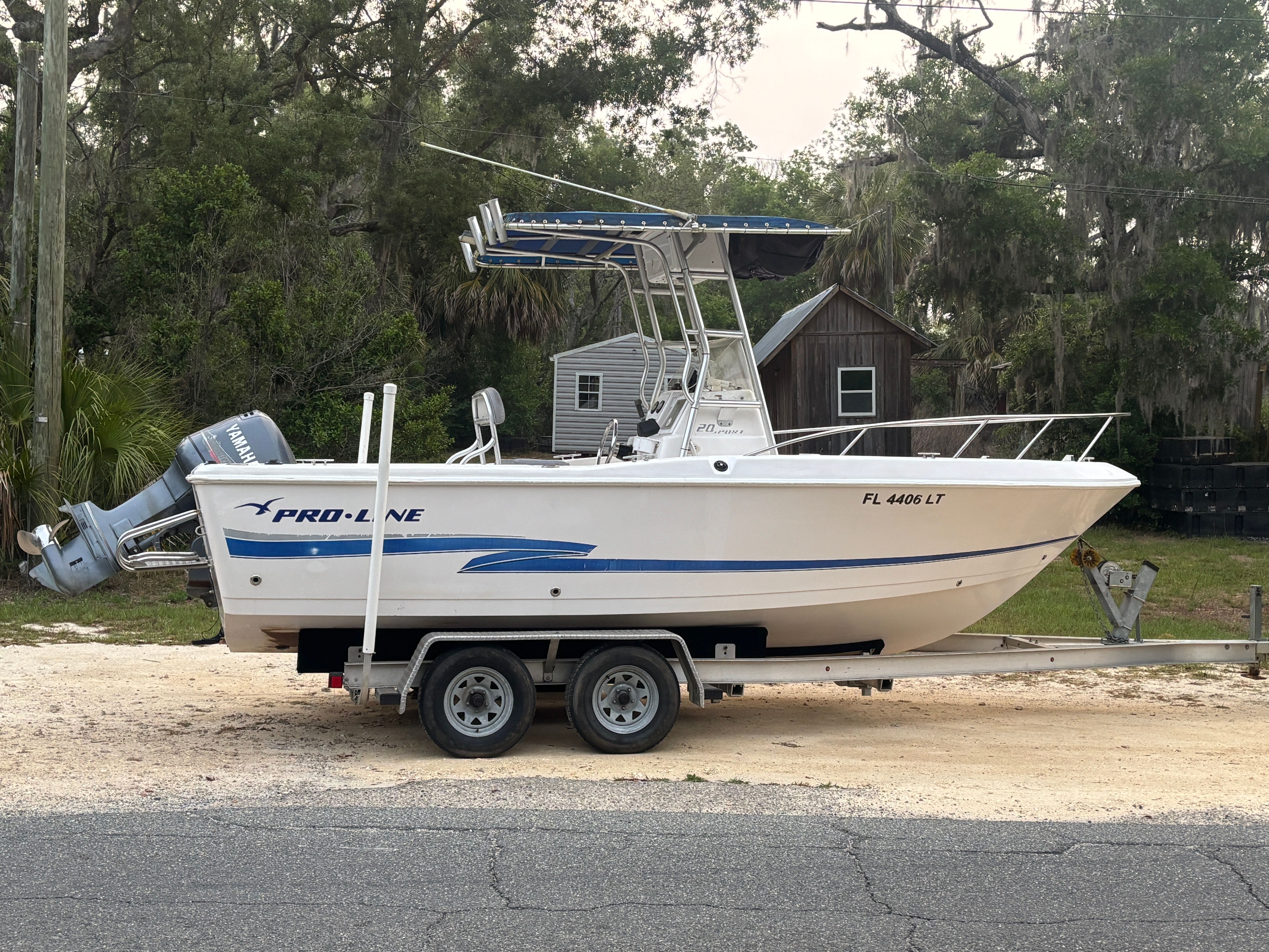 2003 Pro-Line Sport 20 boat on trailer, side view.