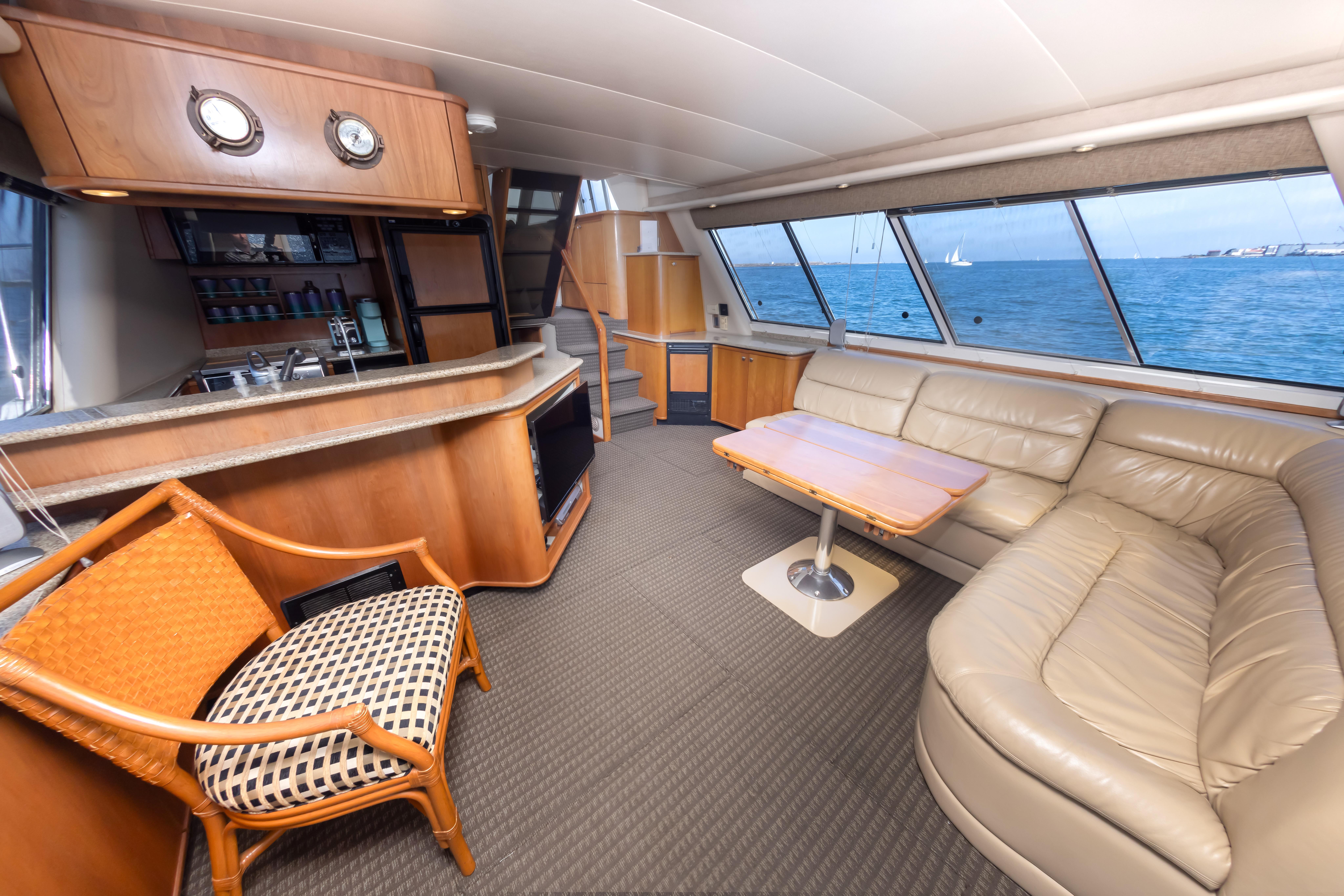 Luxurious interior of 2004 Meridian 490 Pilothouse yacht with leather seating and ocean view.