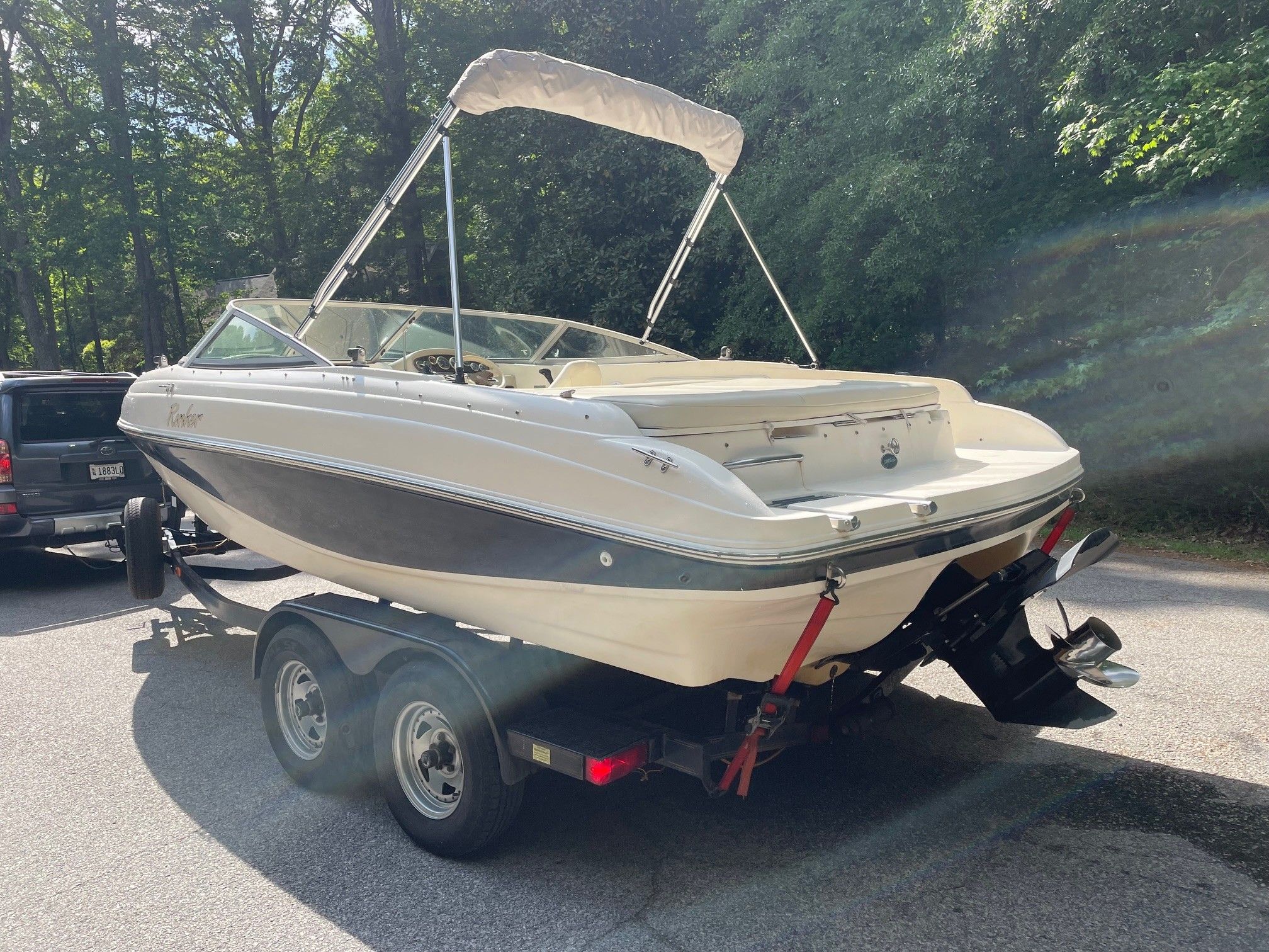2002 Rinker 212 Captiva Bowrider parked on trailer outdoors.