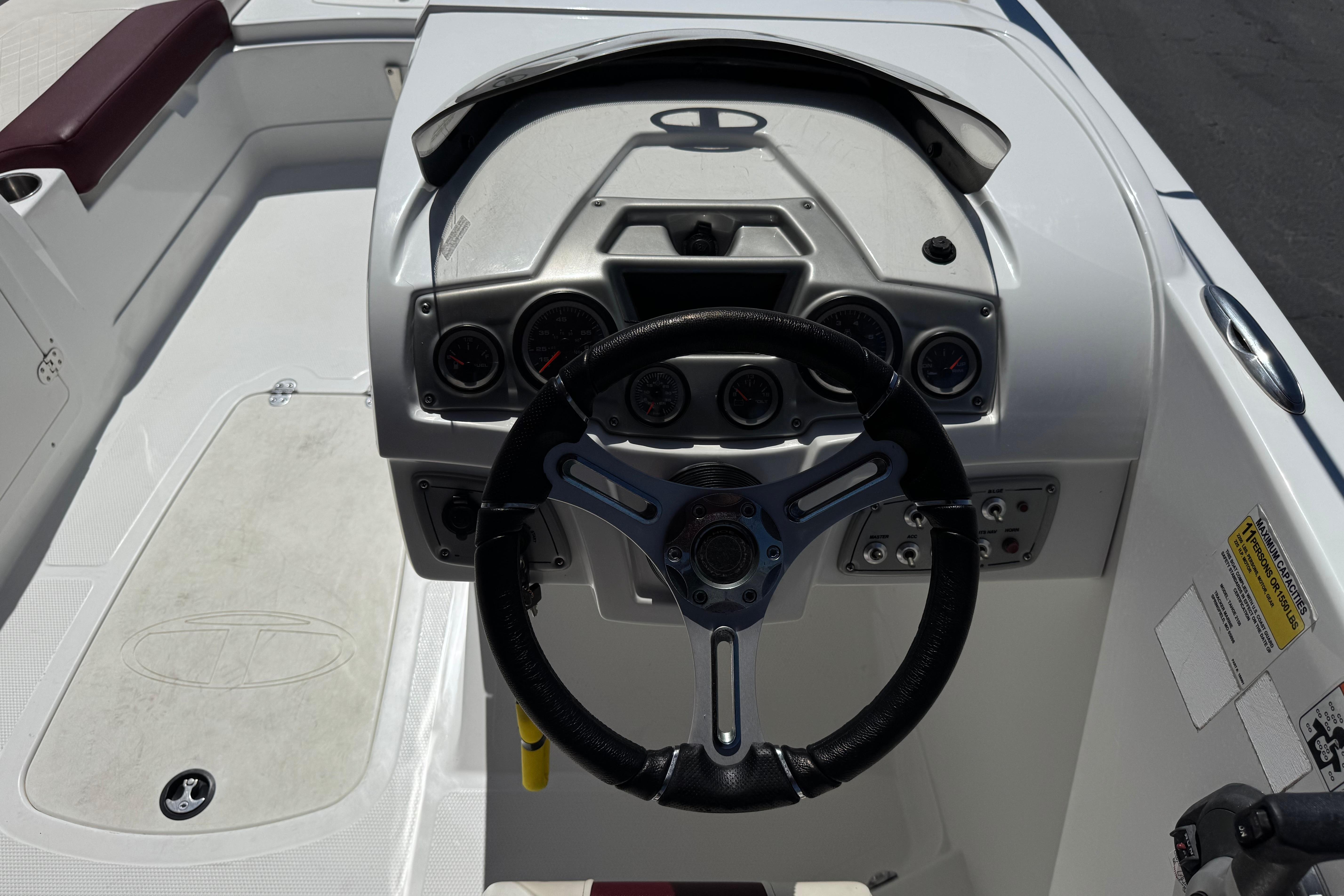 Steering console of a 2017 Tahoe 2150 boat with gauges and controls.