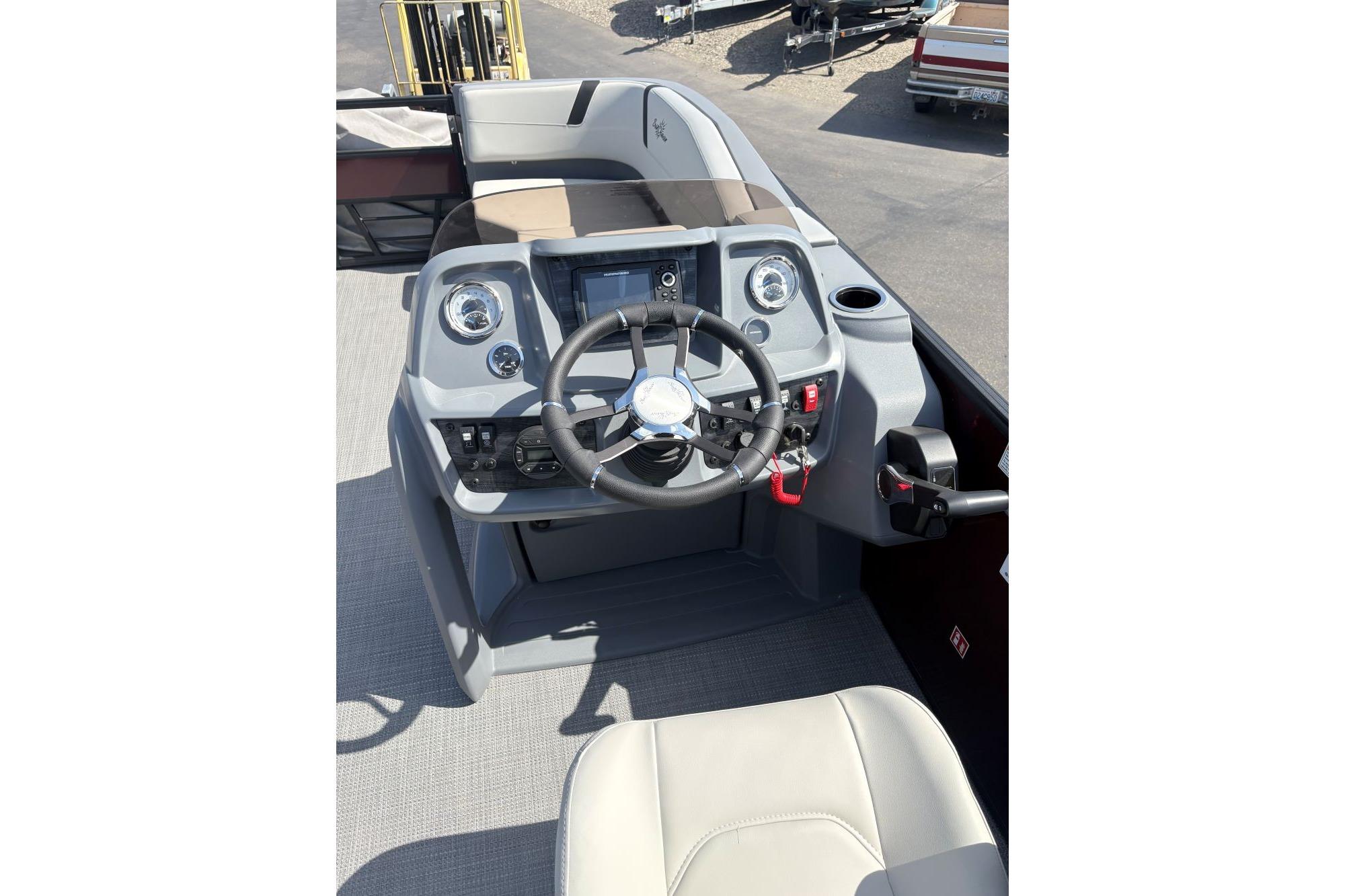 Steering console of 2026 SunChaser Lucerne 22 LR DH pontoon boat, featuring modern controls.