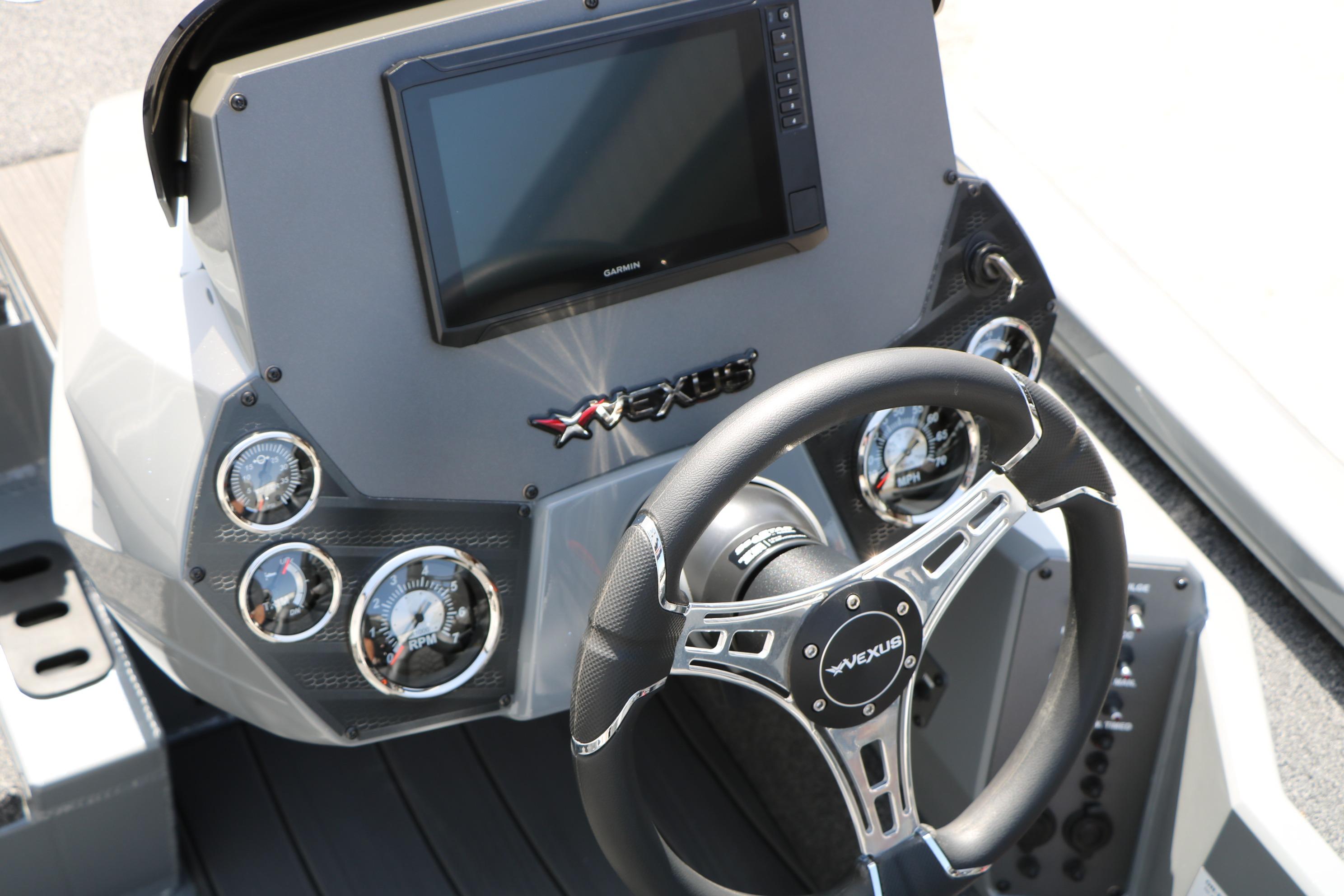 2026 Vexus AVX1980 boat dashboard with steering wheel and digital display.