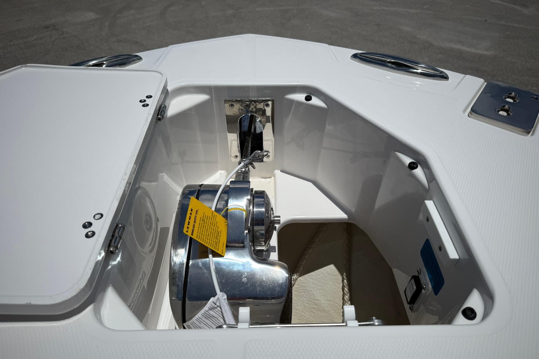 2026 Edgewater 250CC boat anchor compartment with stainless steel hardware and storage space.