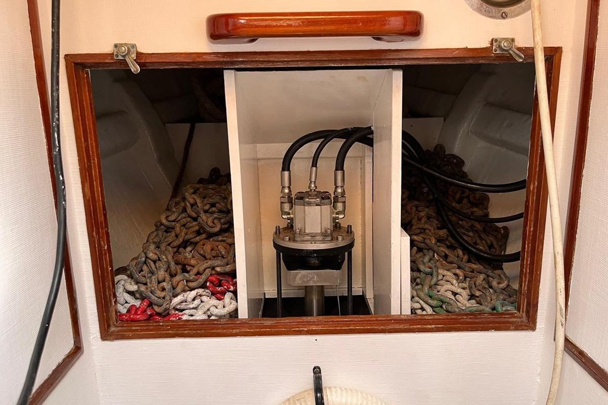 Interior of a 1978 Bowman 66 boat showing anchor chains and hydraulic system.