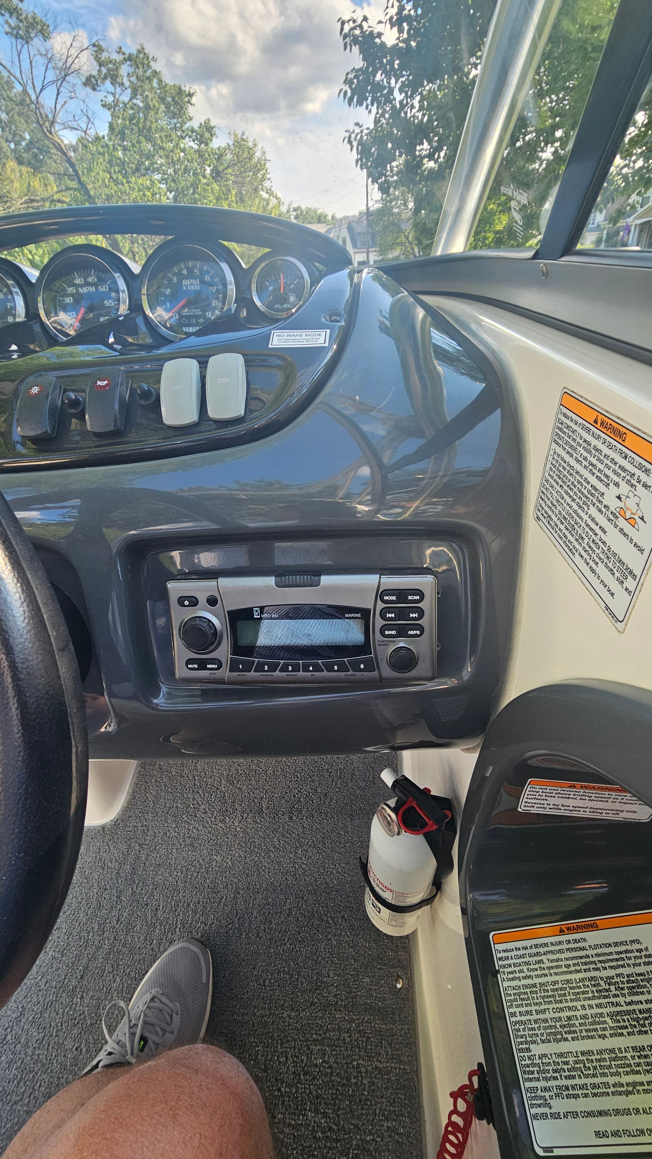 The image shows the dashboard of a Yamaha AR210 boat with controls and a radio.