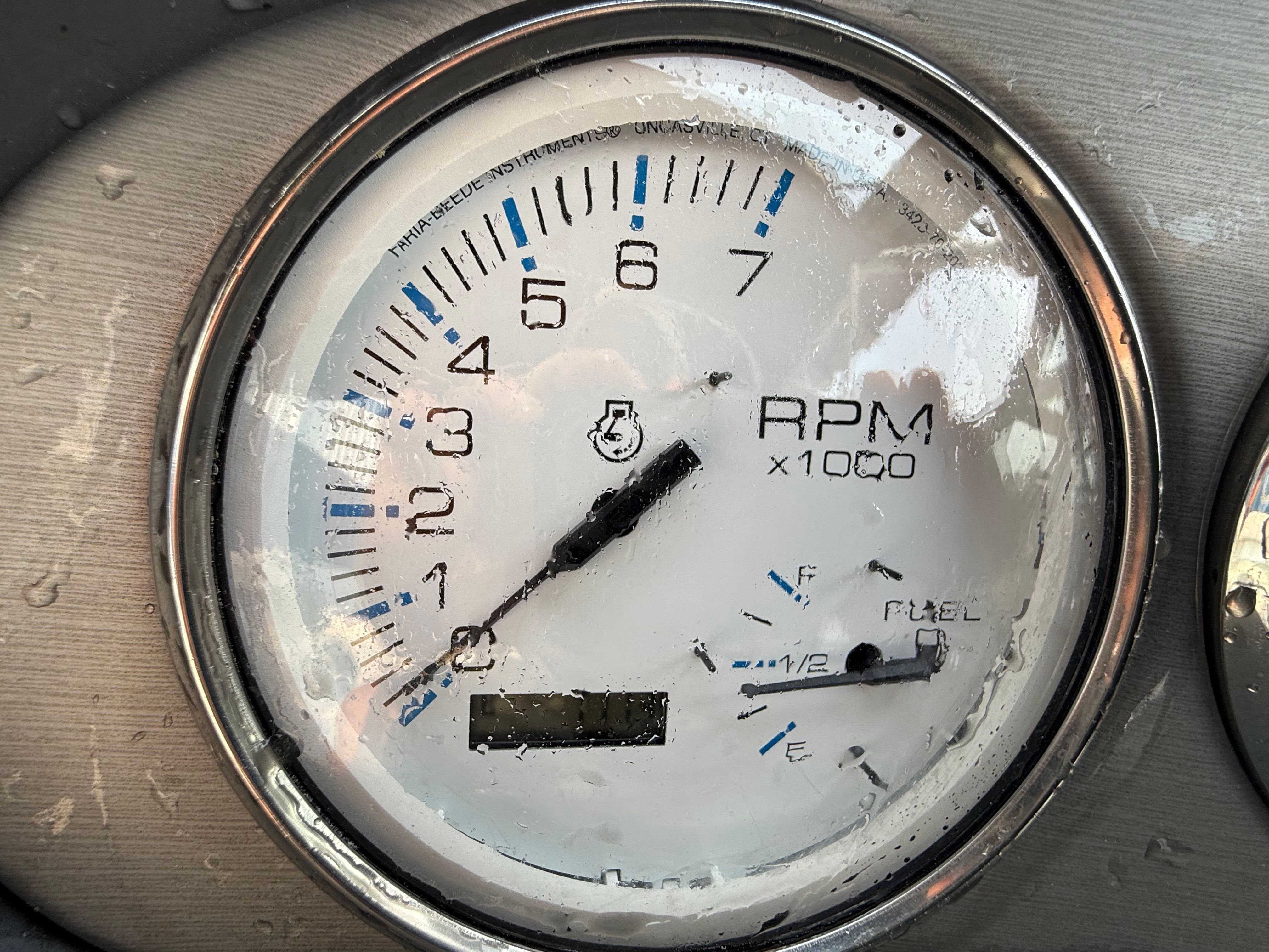 A tachometer with water droplets shows up to 7,000 RPM.