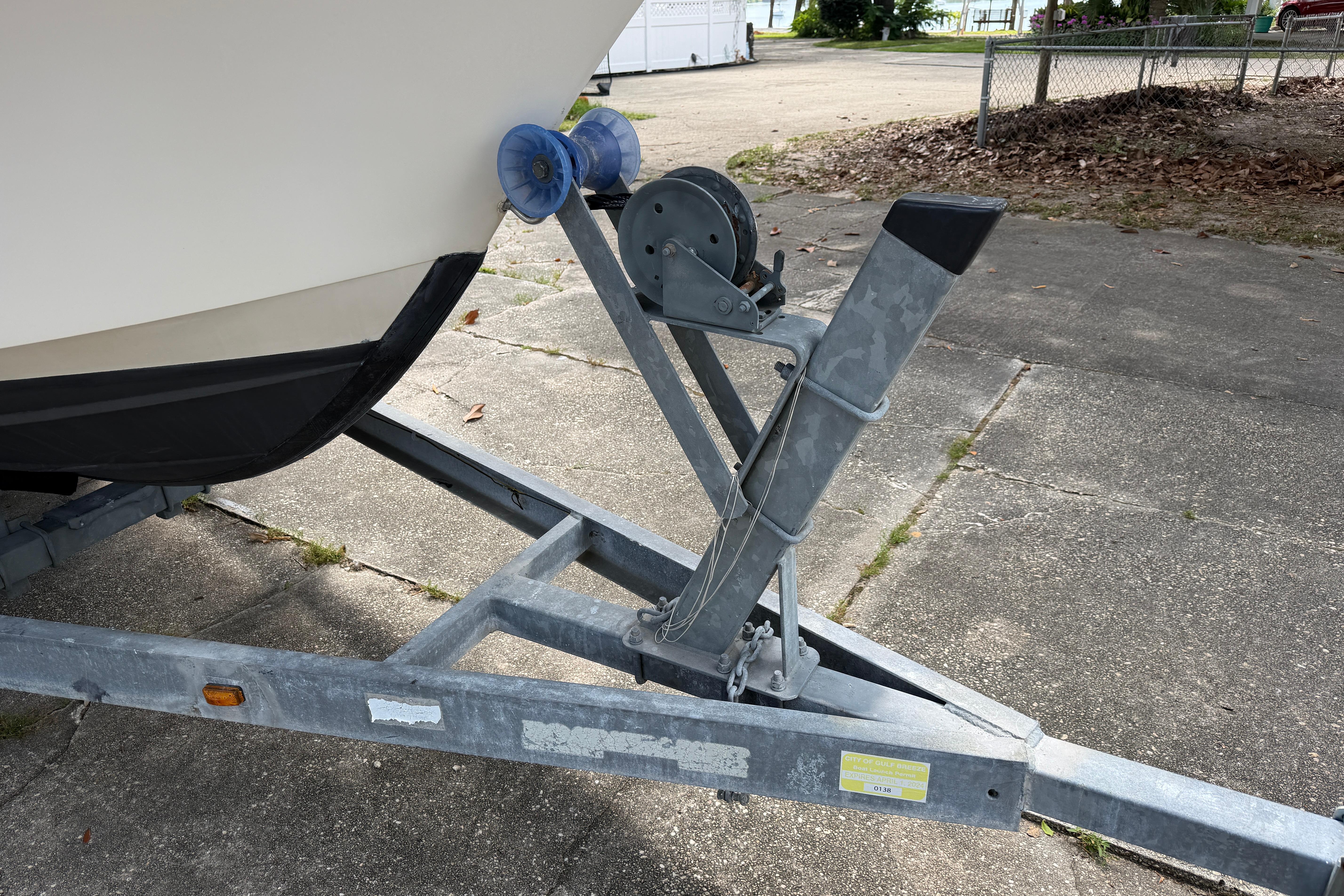 Boat trailer with Grady-White Seafarer 226, 1987 model, parked on concrete.
