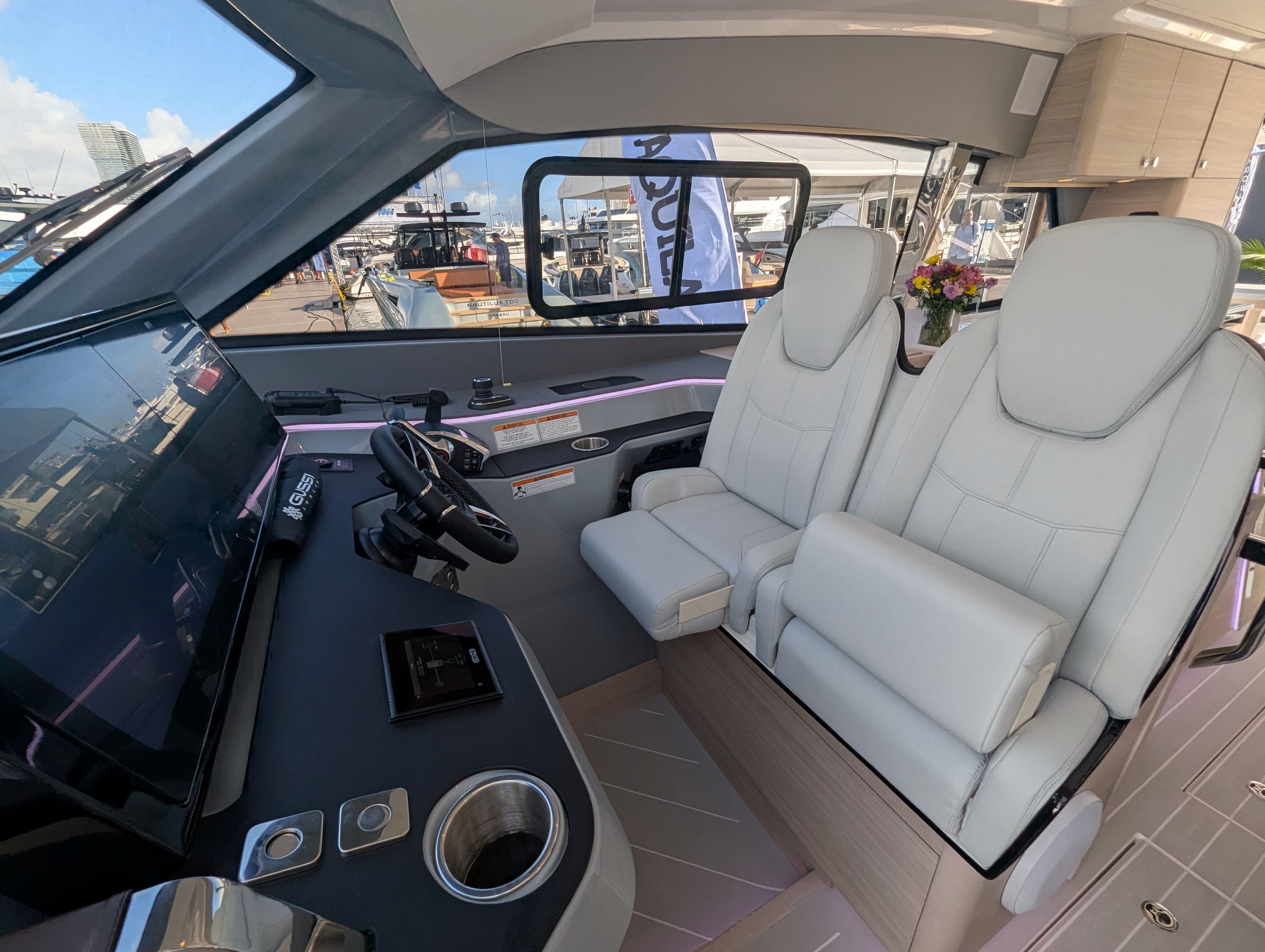 Interior of 2026 Aquila 42 Coupe yacht with modern helm and luxurious seating.