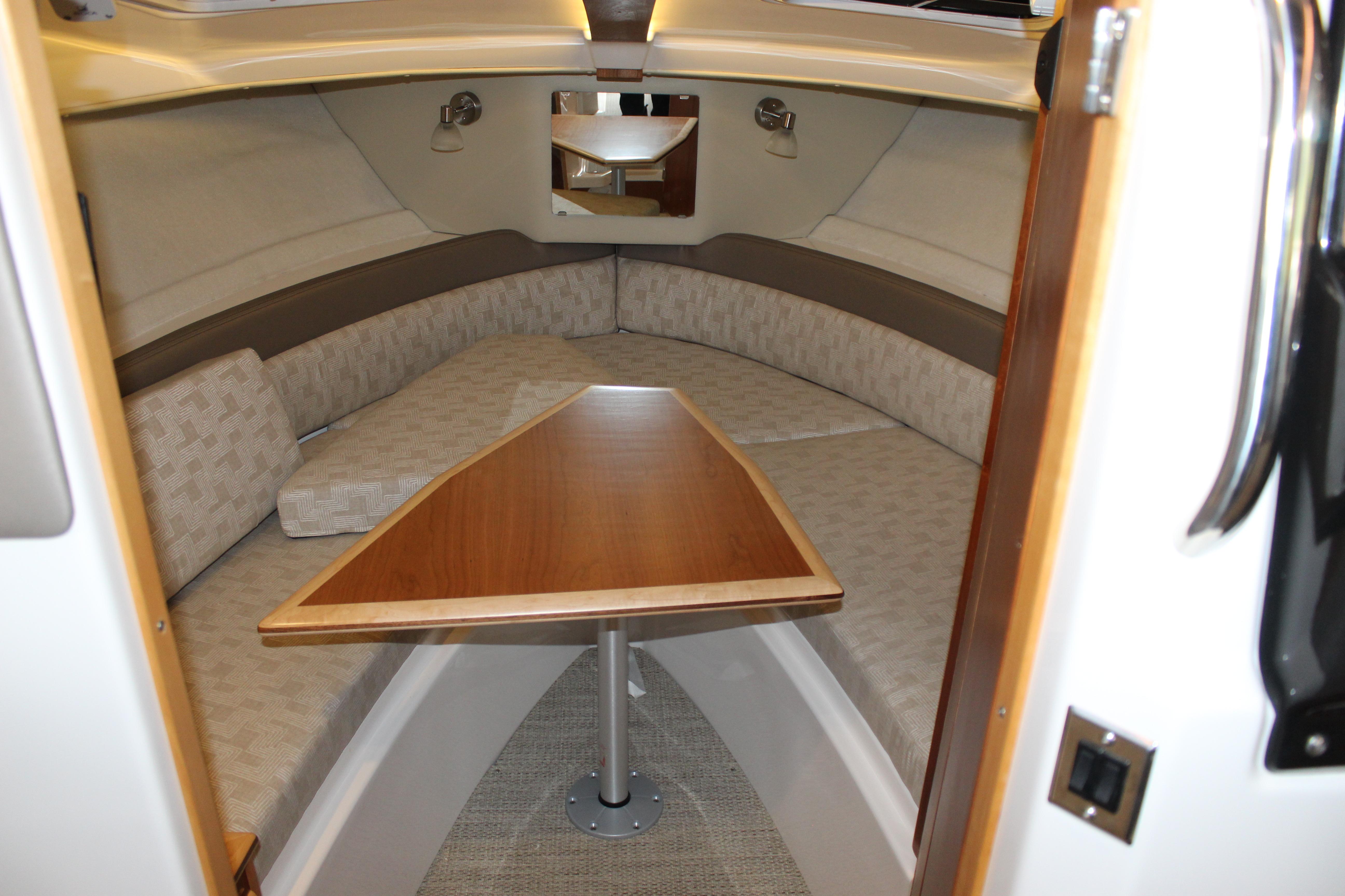 2024 Cutwater C-248 Coupe interior cabin with cozy seating and wooden table.