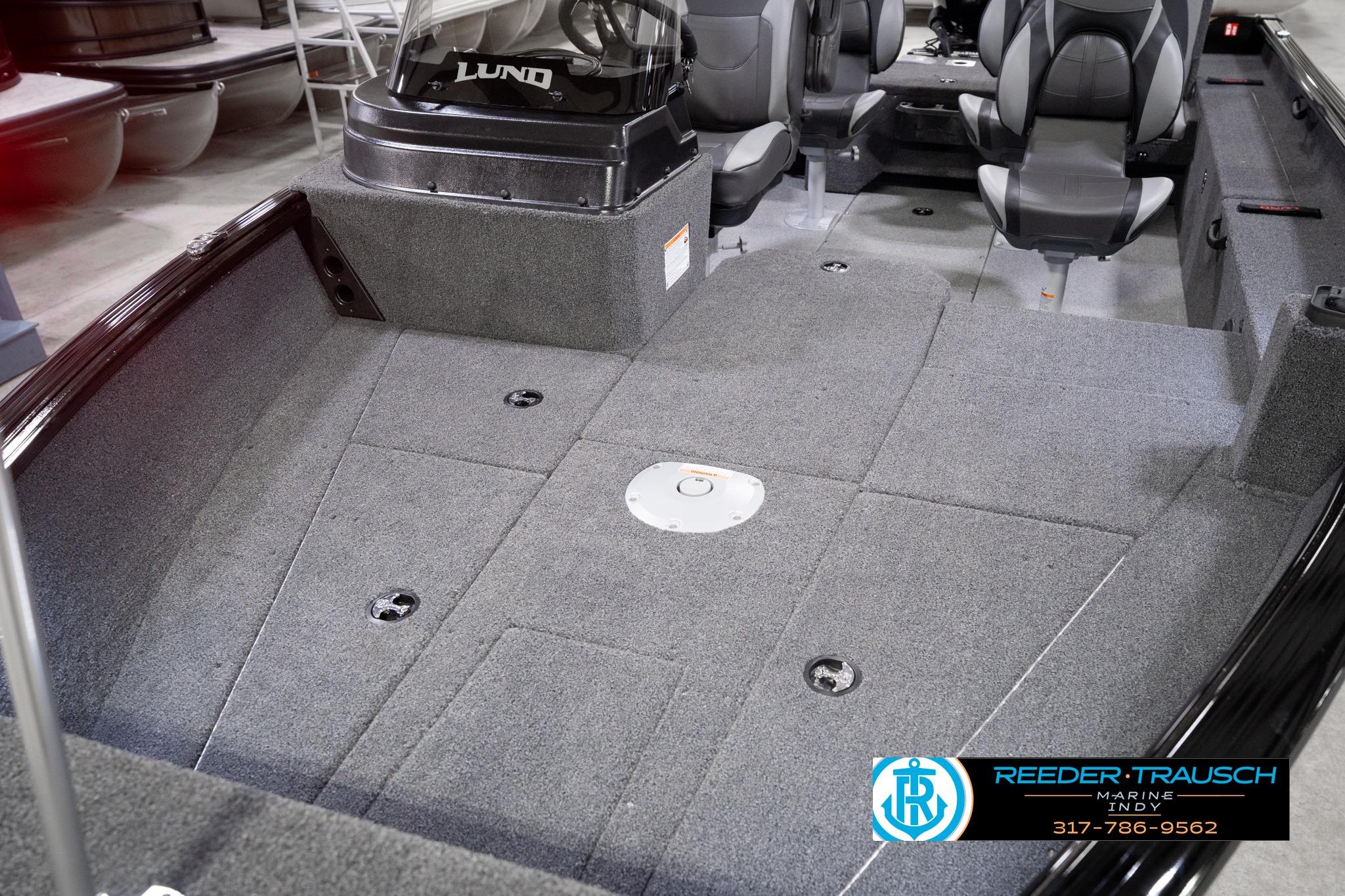 2026 Lund 1775 Impact XS SS boat interior with gray carpet and seating arrangement.