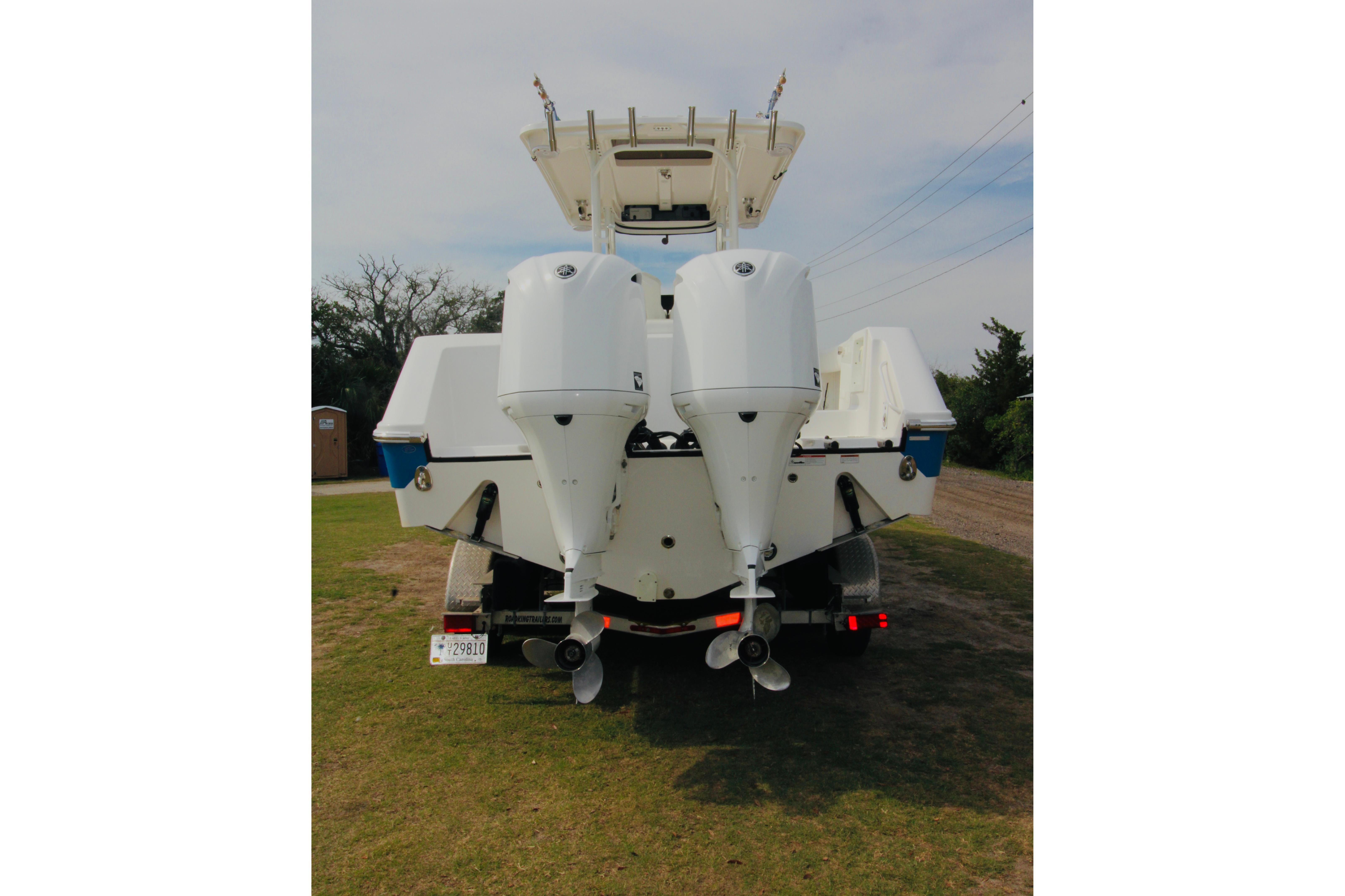 2022 Edgewater 280CC boat with dual outboard motors on a trailer.