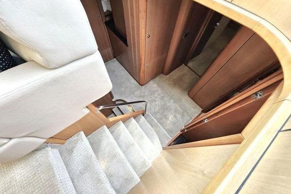 Interior view of 2005 Sunseeker Manhattan 66 yacht, featuring carpeted stairs and wooden paneling.