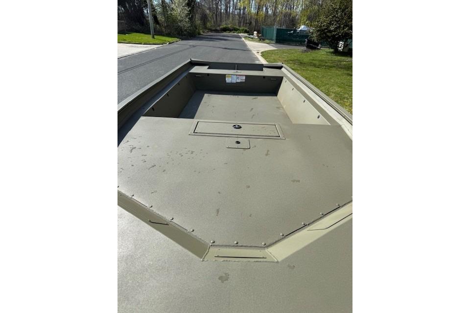2026 Tracker Grizzly 1860 Utility boat on a road, showcasing its spacious interior.