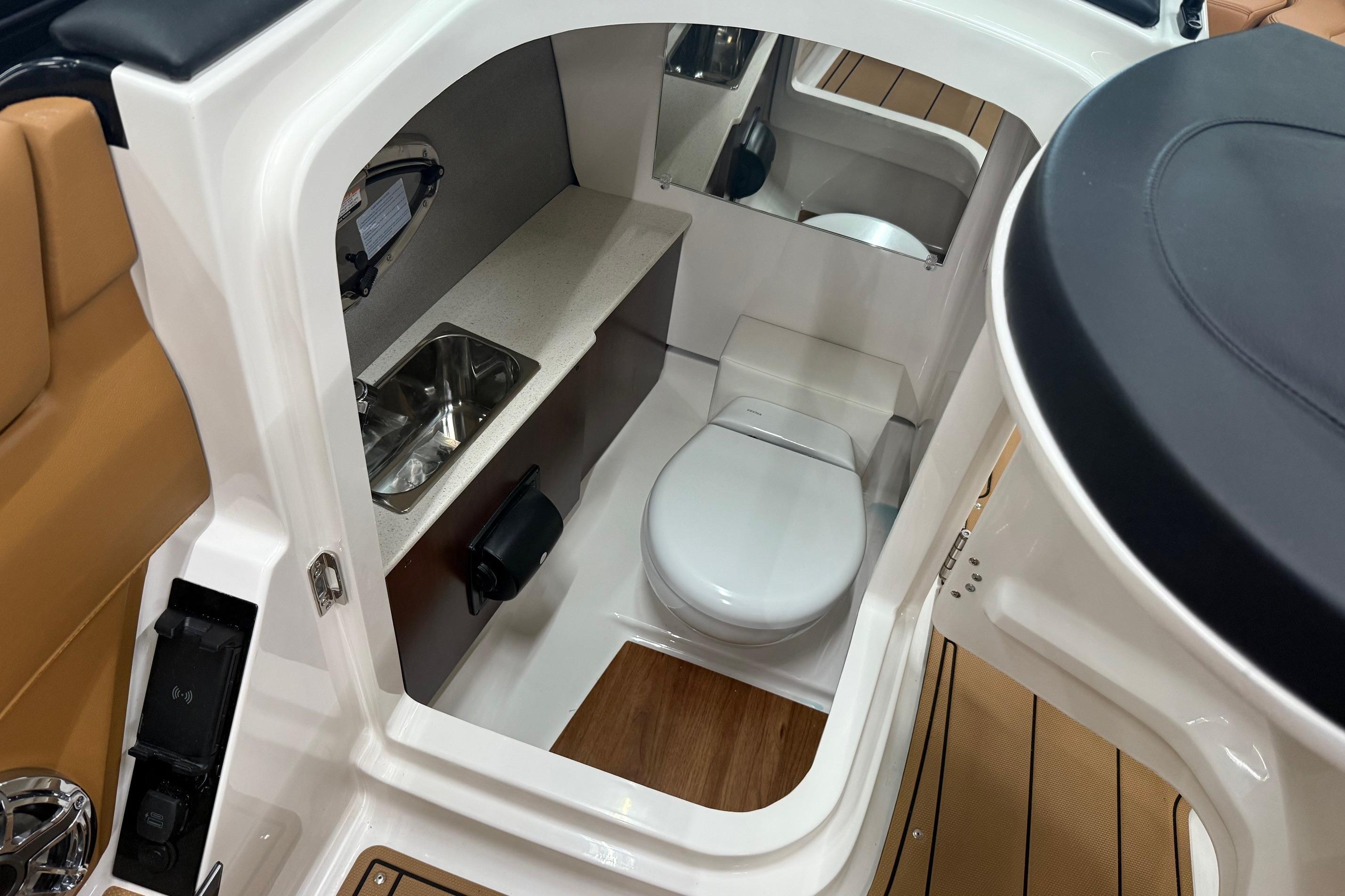 2026 Chaparral SSX 6 boat interior with compact bathroom and sink.