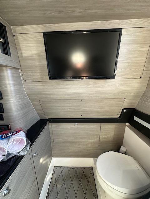 2019 Mystic Powerboats M4200 interior with TV and toilet in modern design.