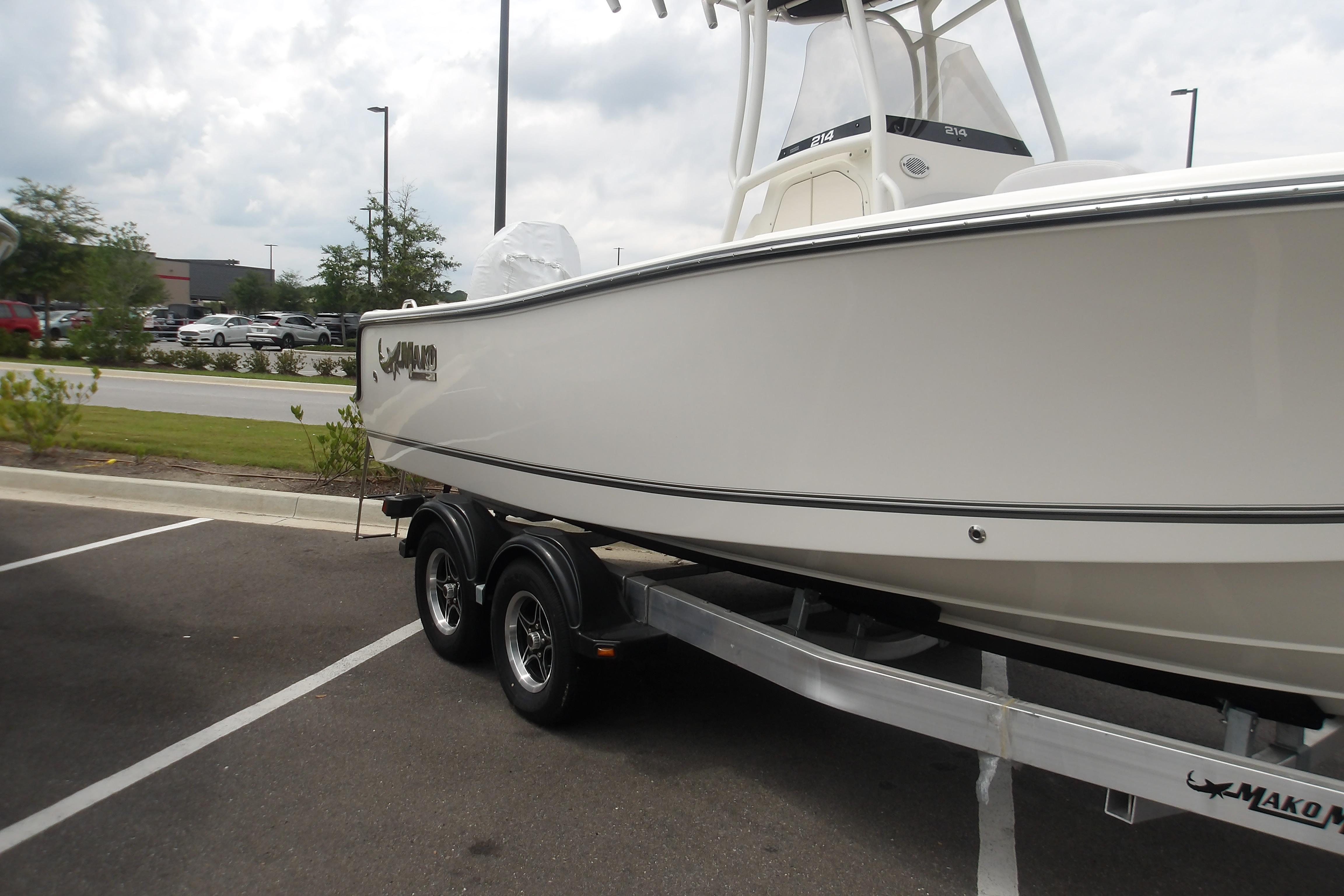 2025 Mako 214 Center Console boat on trailer in parking lot.