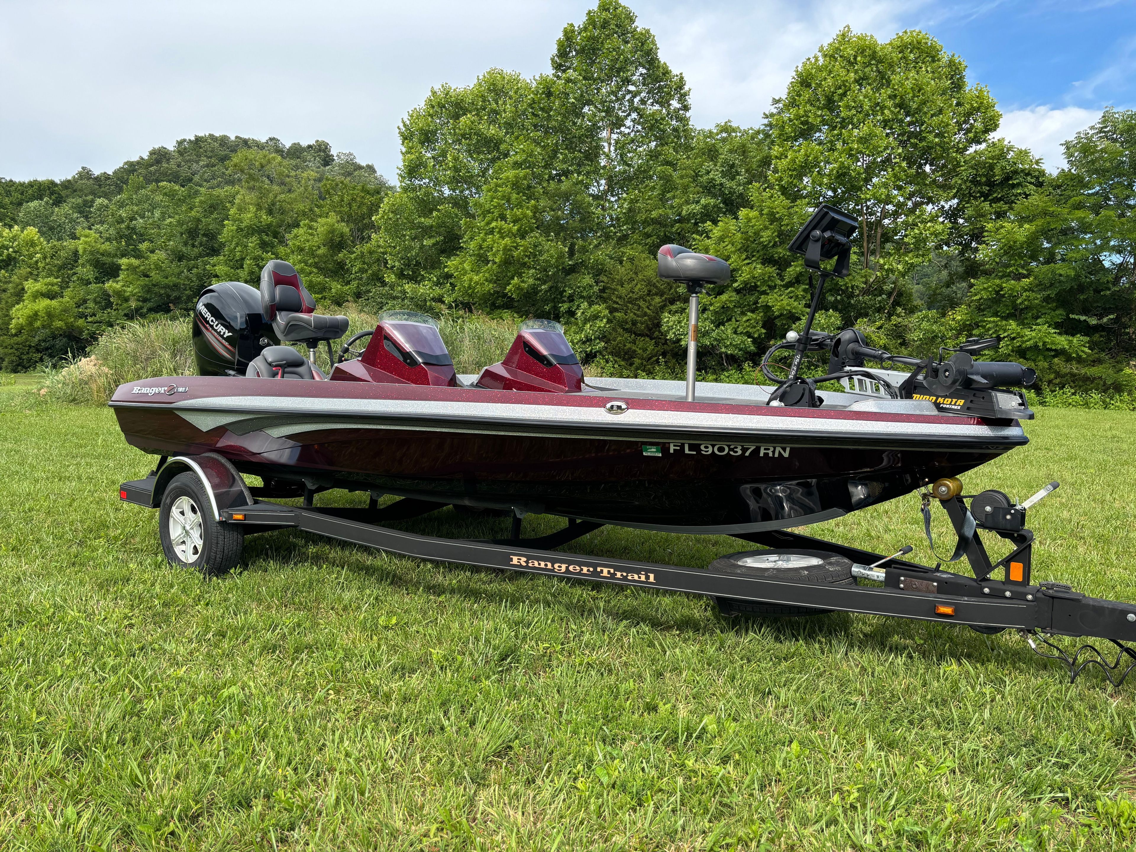 A 2016 Ranger Z 185 boat on a trailer, set on a grassy field.