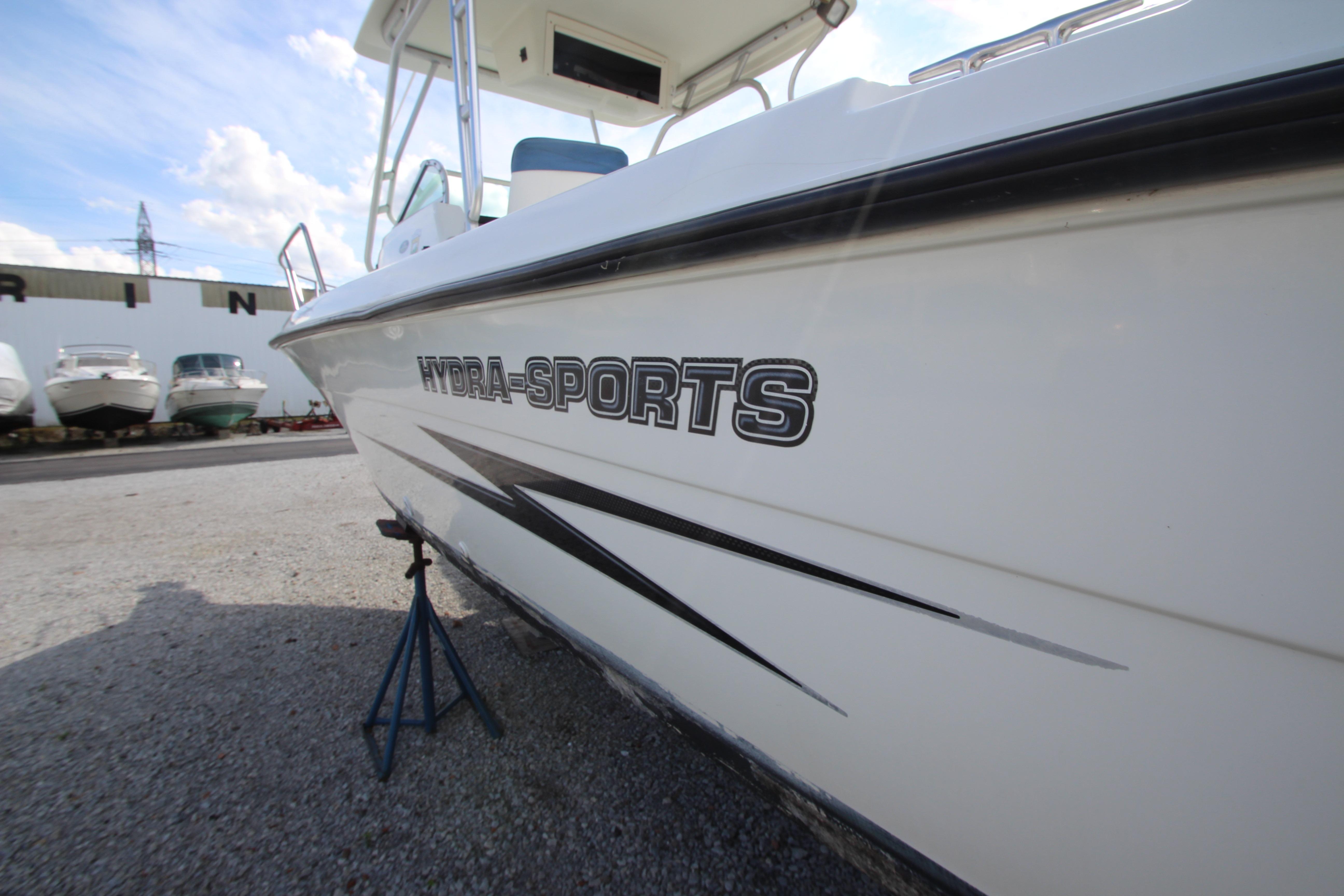 2002 Hydra-Sports 230 WA boat on stand, marina background, clear sky.