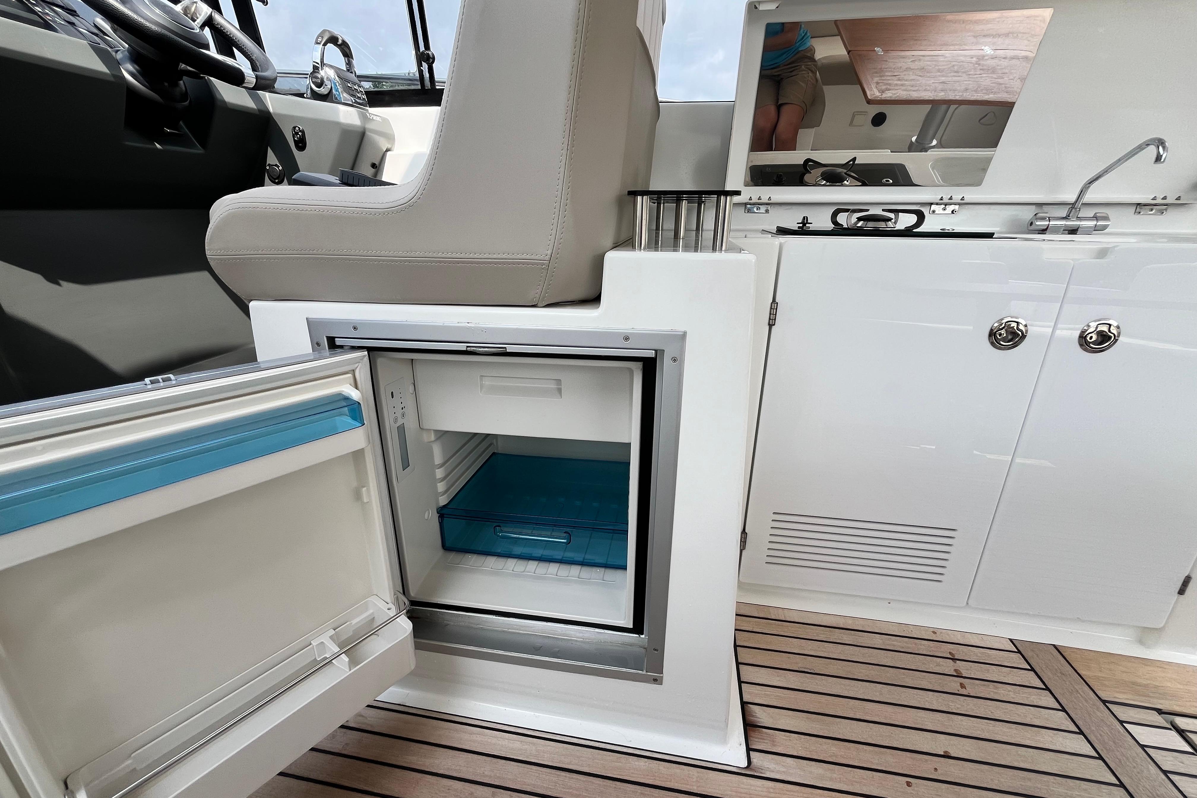 2017 Jeanneau Leader 40 yacht interior with open fridge and kitchenette.