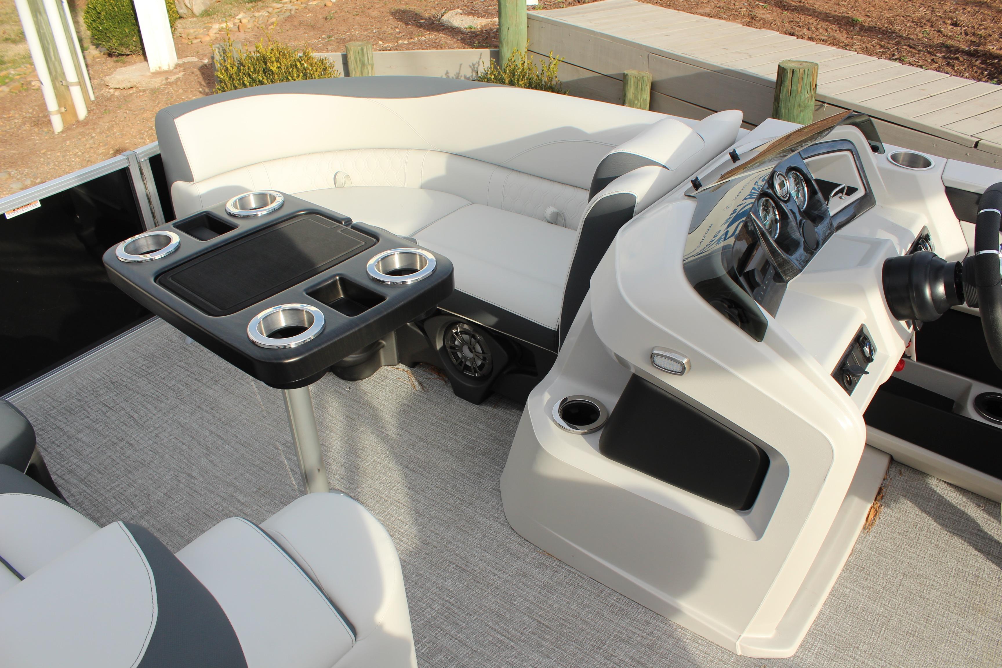2026 Tahoe Pontoon LTZ interior with seating, table, and control console.