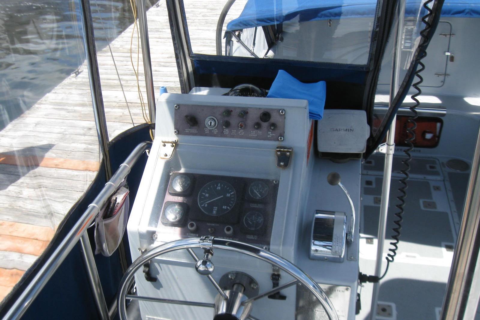 Cockpit of a 1994 Willard US Navy boat with steering wheel and control panel.