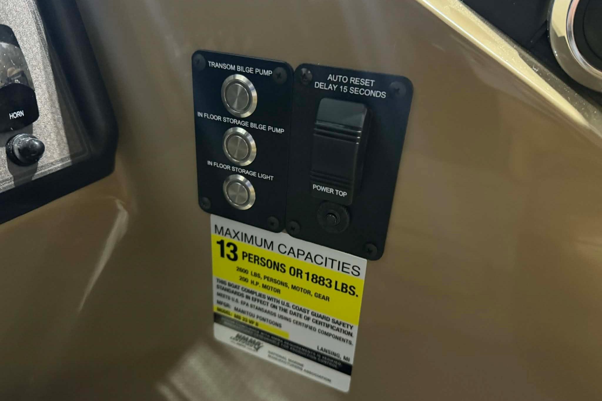 Control panel of 2026 Manitou Encore VP 230 with capacity label for 13 persons.